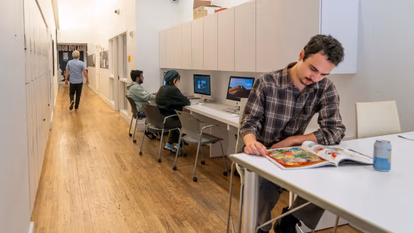 People congregating in an open plan, community oriented lounge.