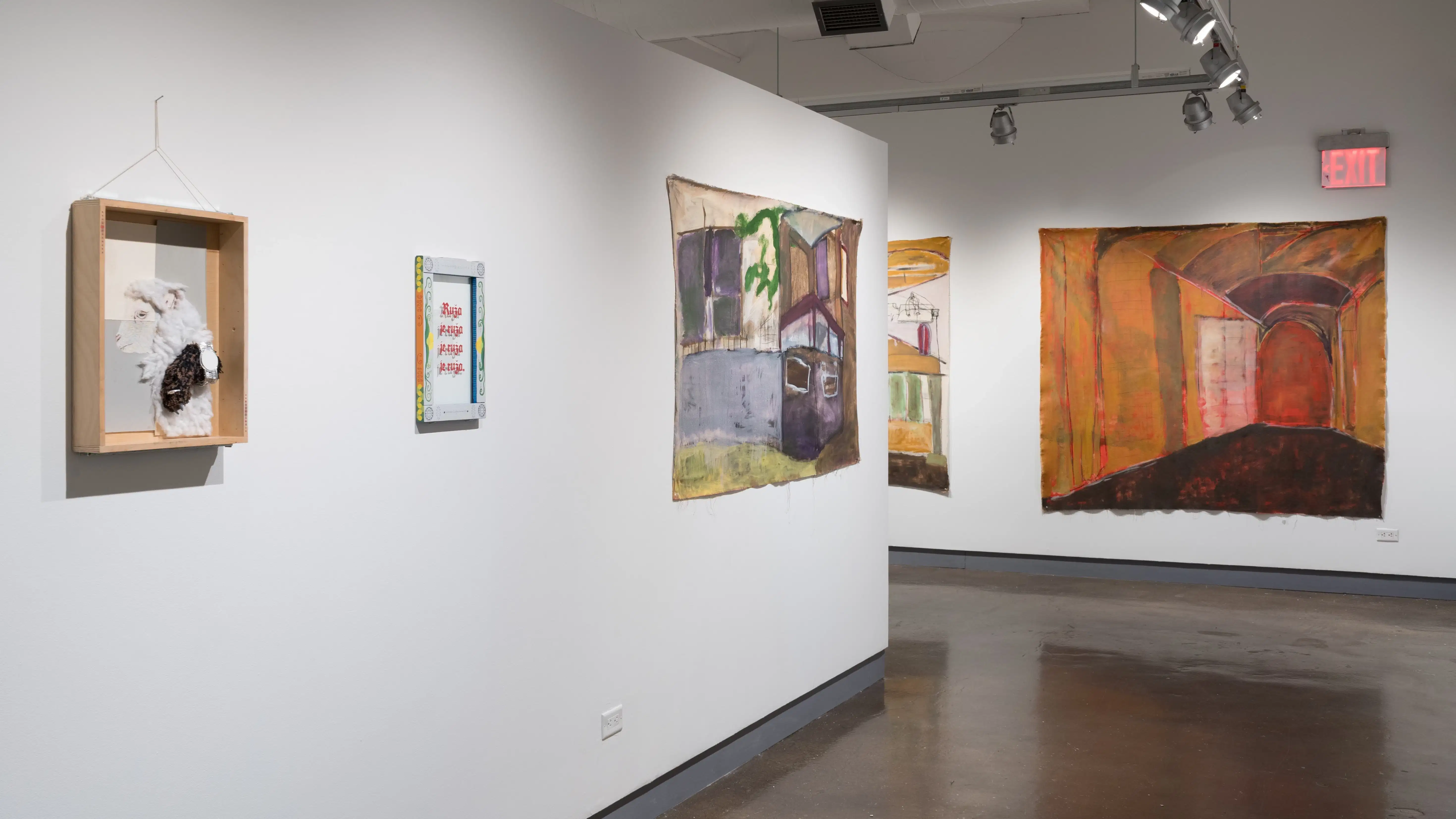 Three works hang on the left side of a corner, as large paintings are displayed on the wall in the back.