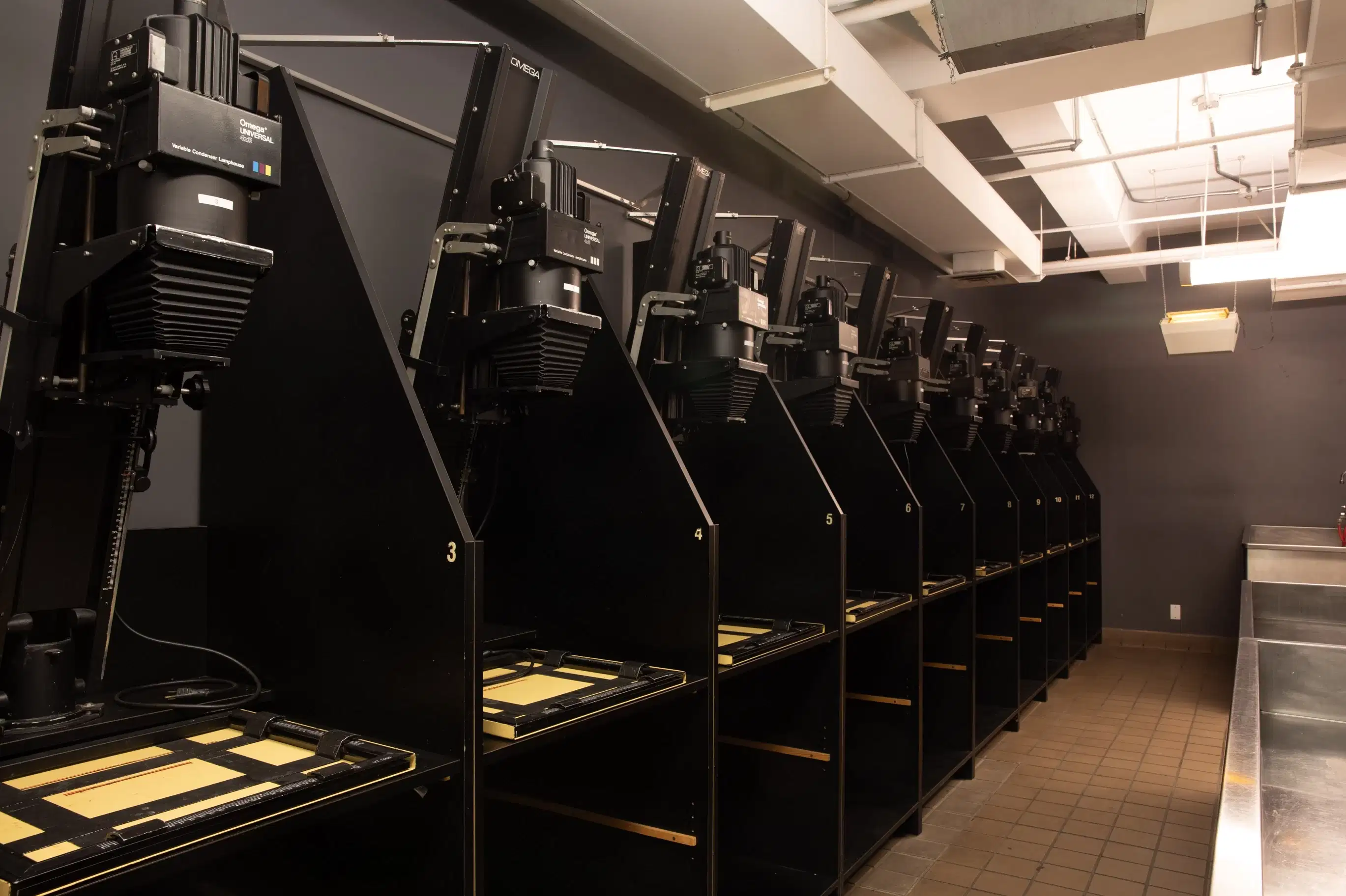 A row of enlargers in the darkroom