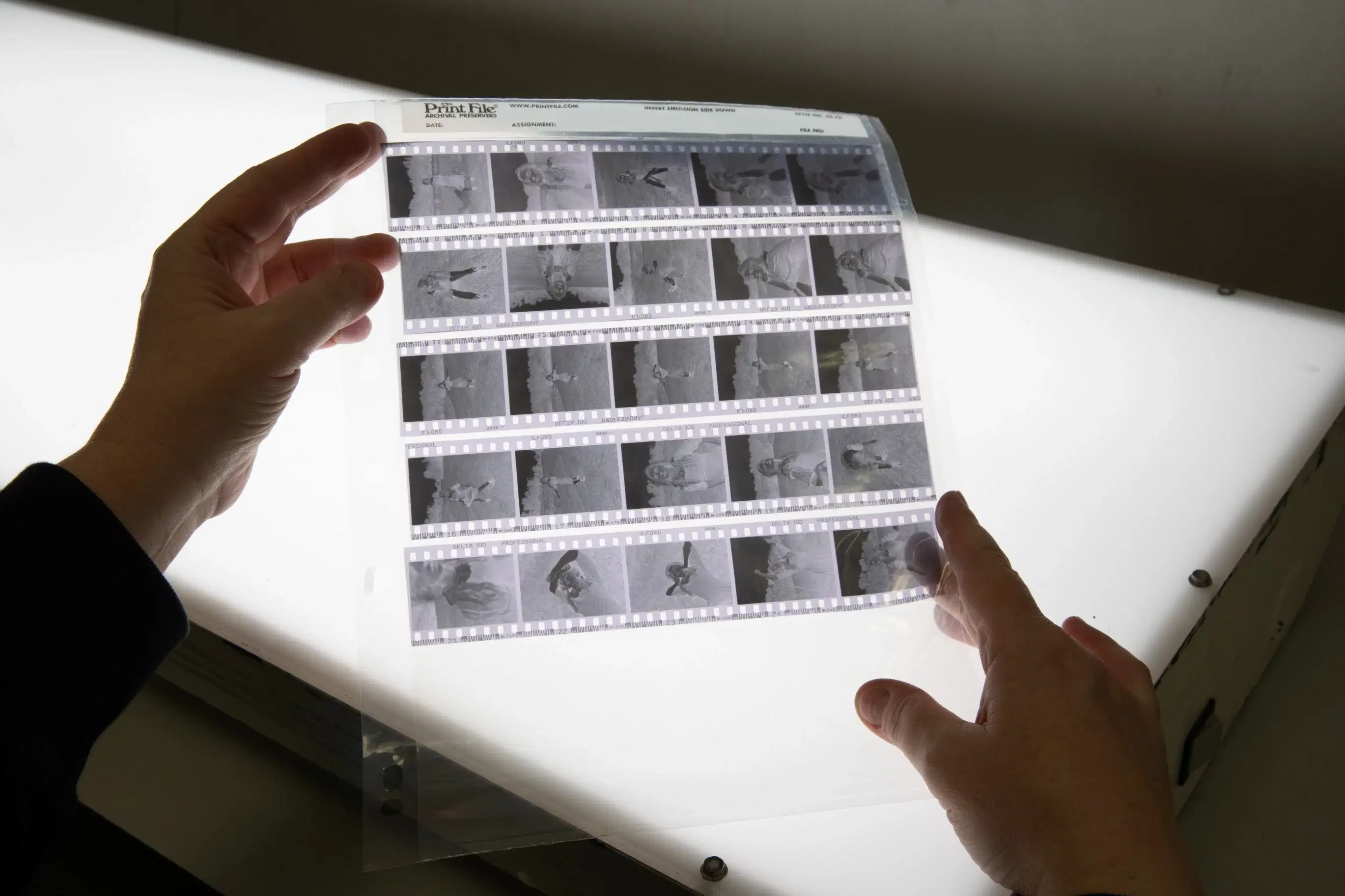 Two hands holding film that has been developed