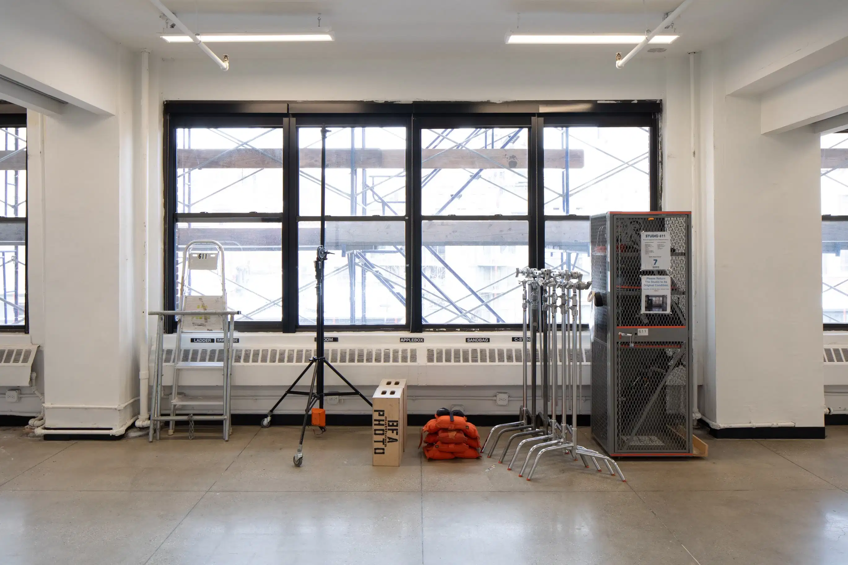 A large window in an open room with photo equipment