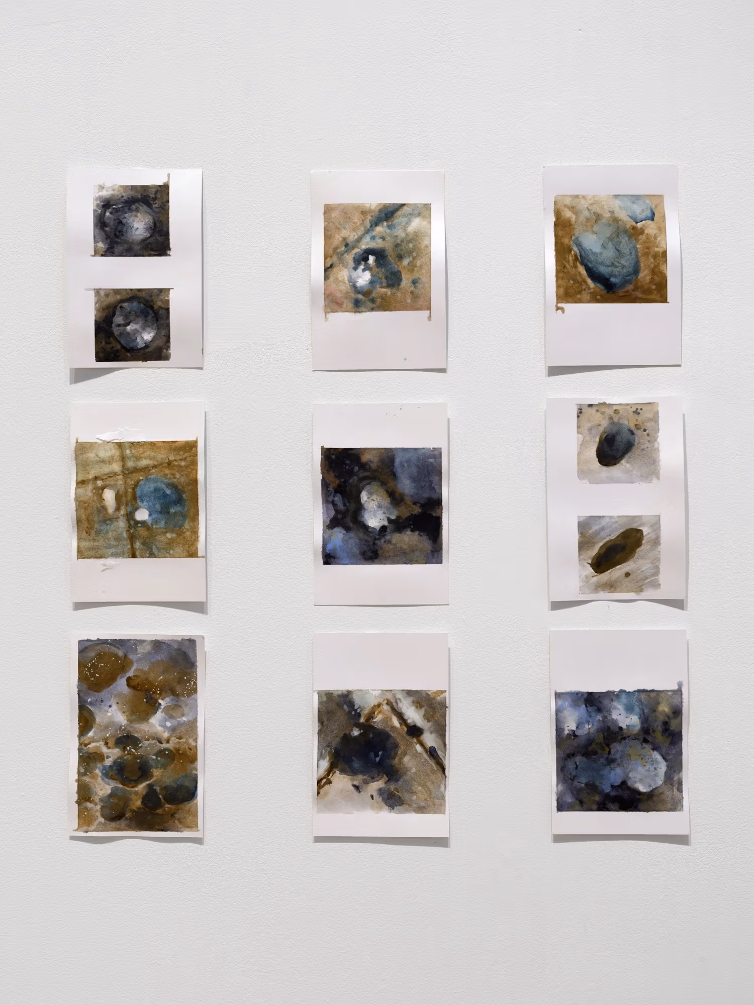 Grid of small ink paintings on paper