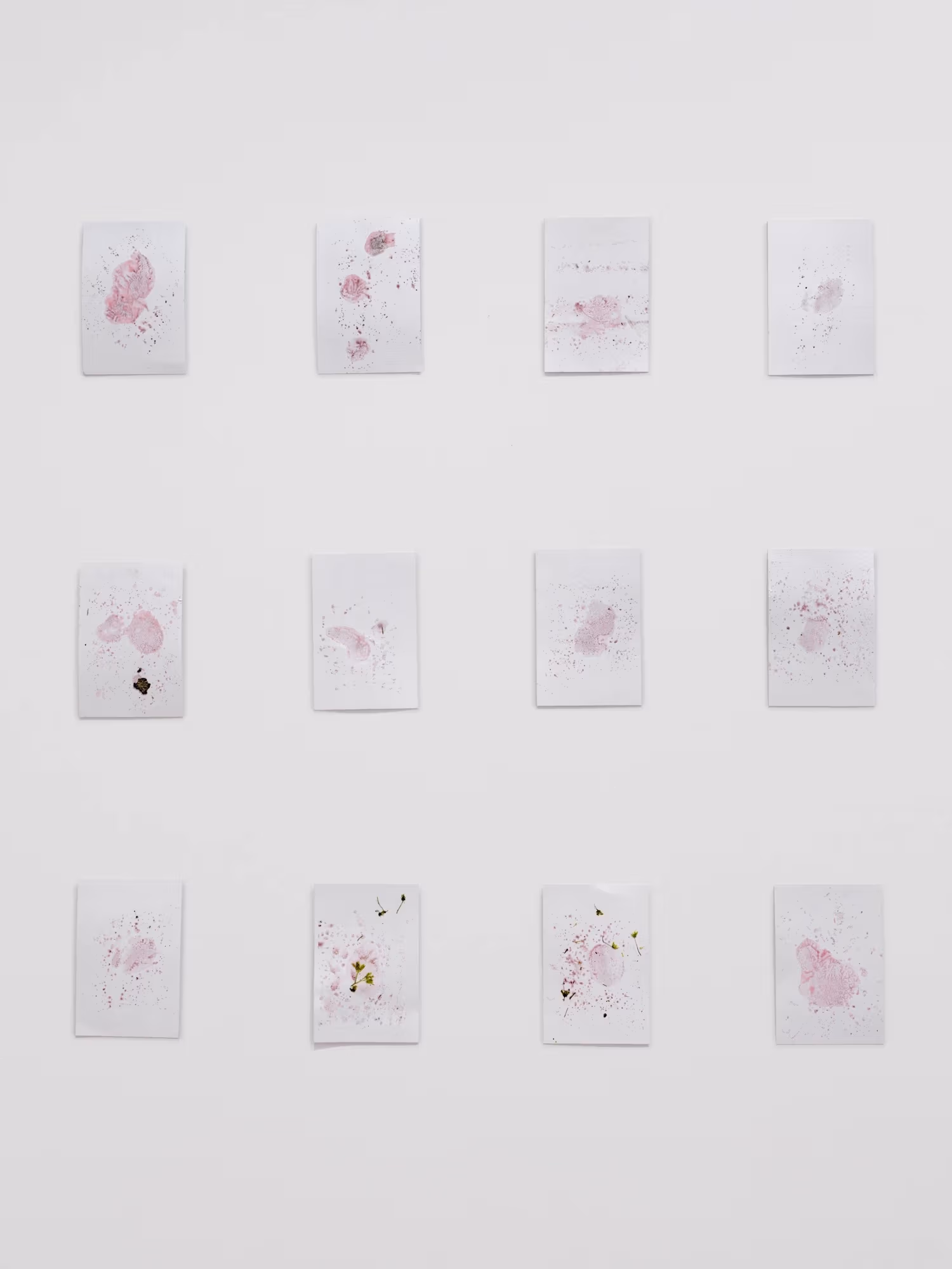 Grid of small paper drawing with red ink.