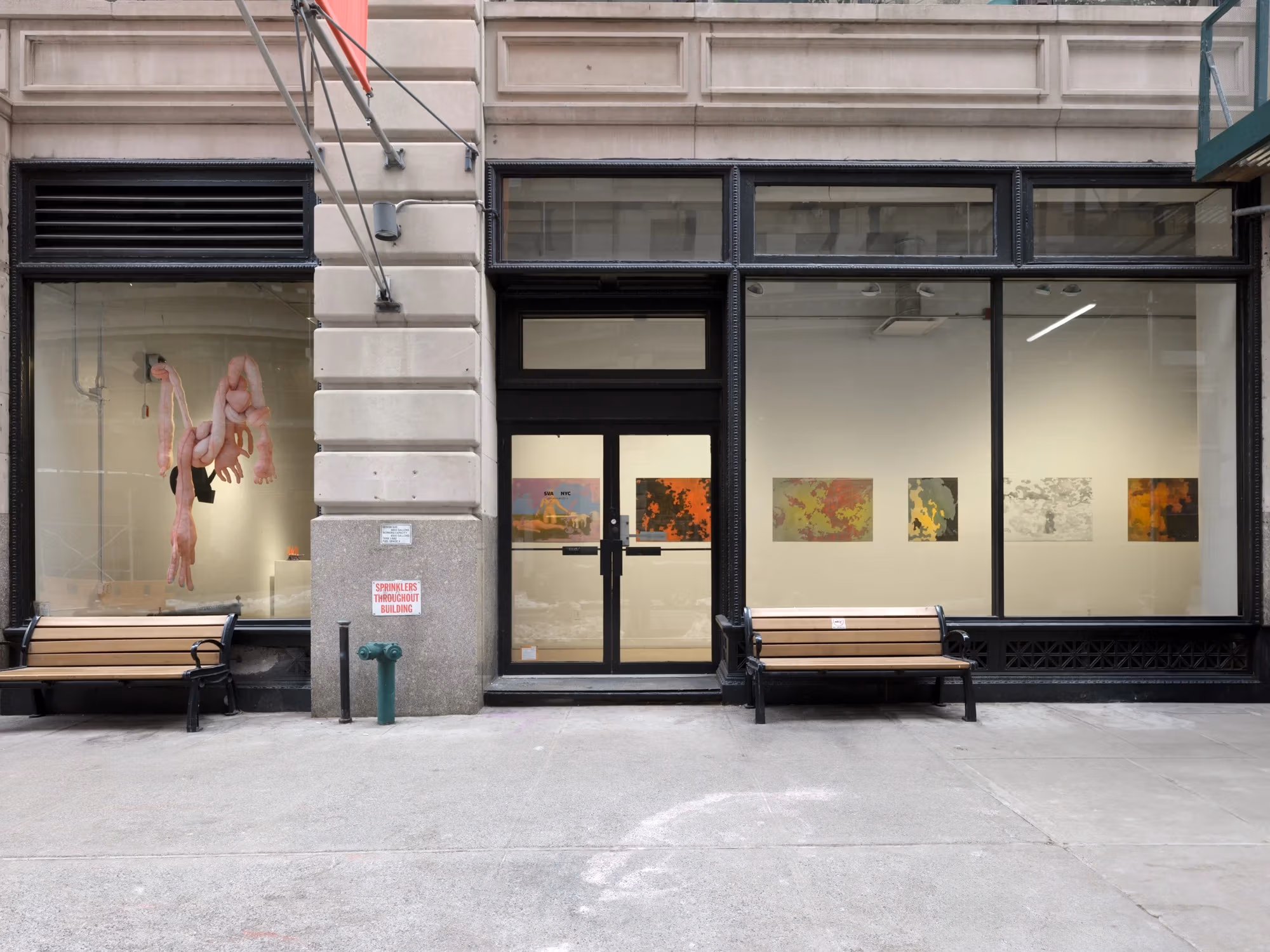 SVA’s Flatiron windows with a sculptural piece on the left, and paintings on the right.