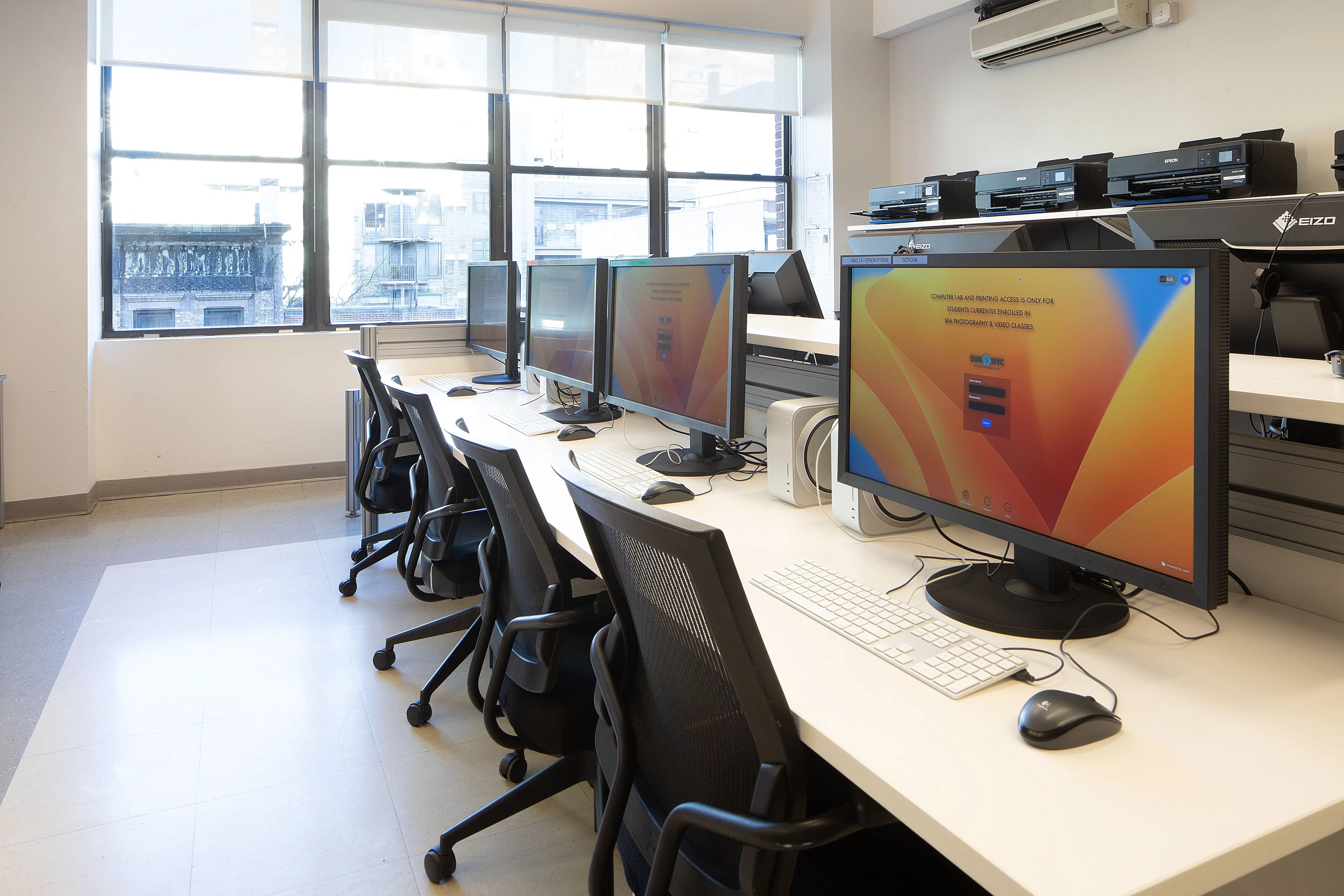 A classroom of monitors and scanners