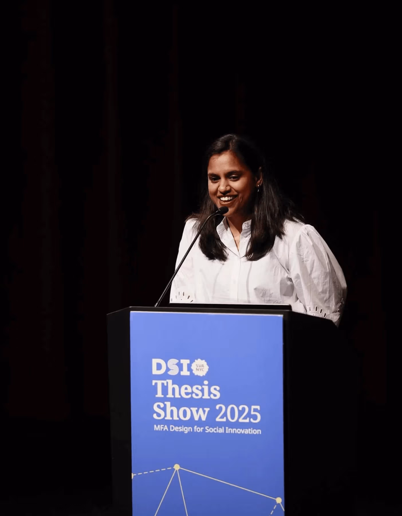 Person speaking at podium with text reading DSI Thesis Show 2025