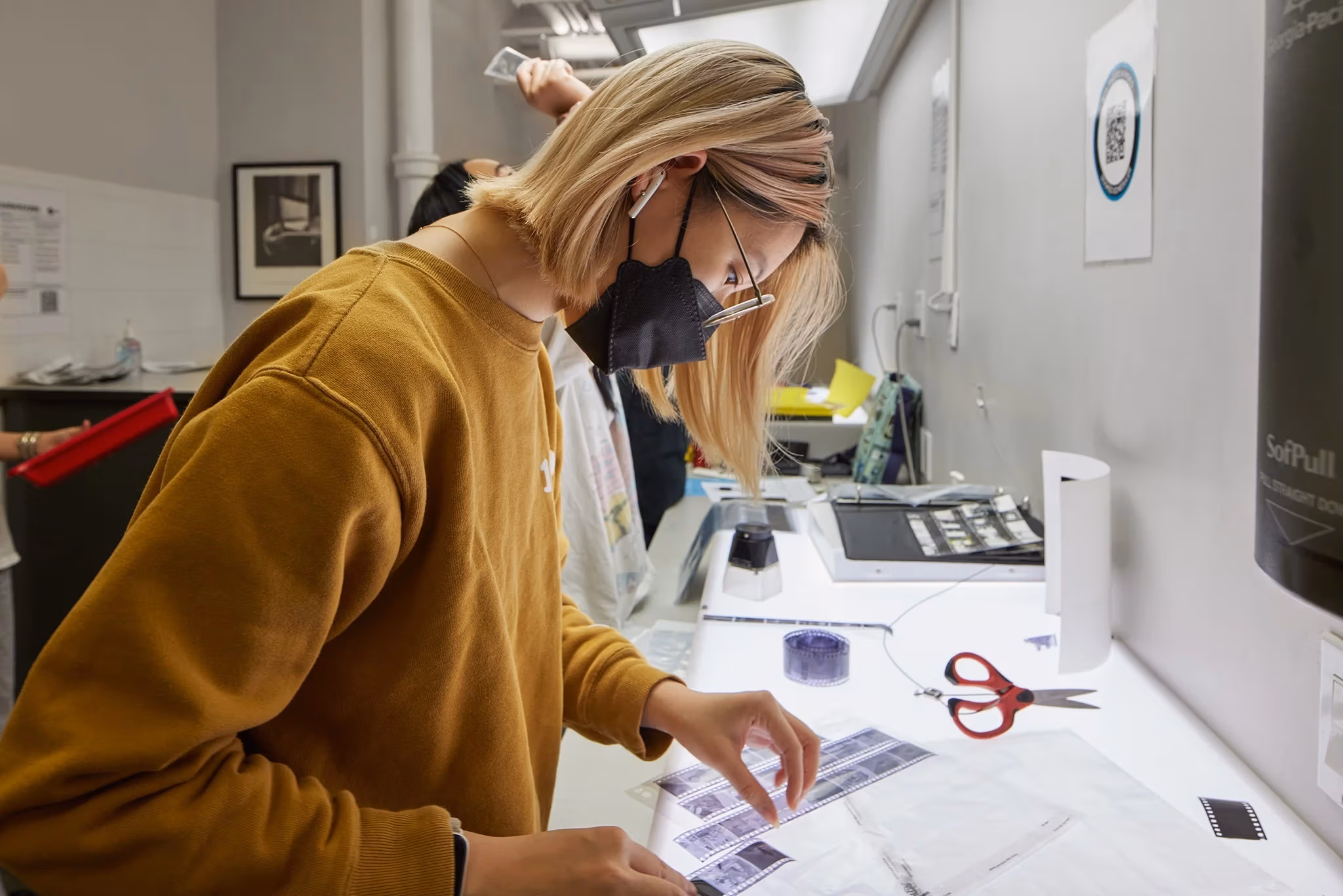 Students look at their developed film on a light table