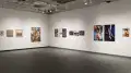 An angled view of the back gallery at Gramercy gallery, showing multiple large prints and framed works on the walls.