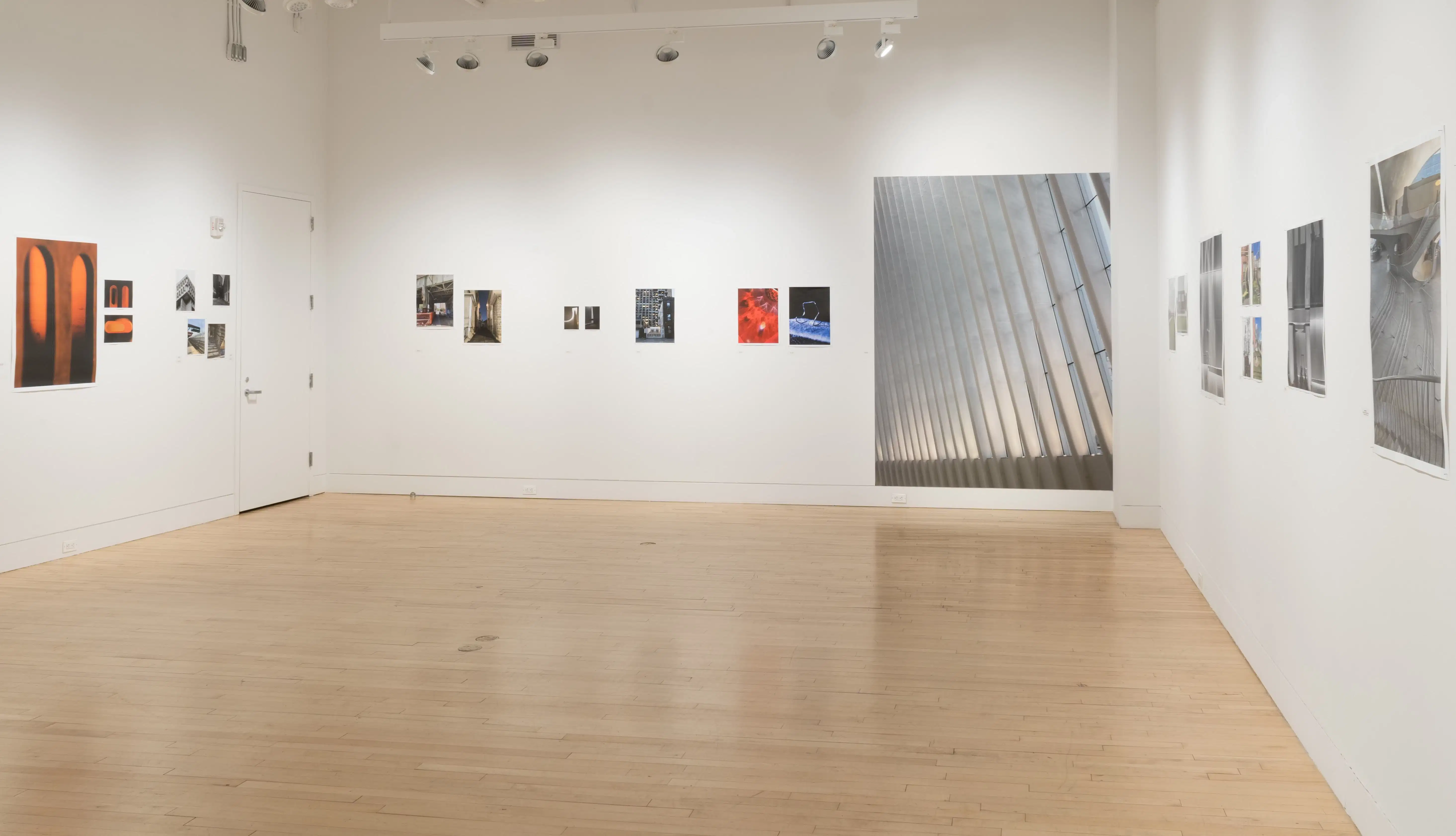 Wide shot of the Flatiron Gallery, showing multiple prints of industrial moments in varying sizes lining the walls.