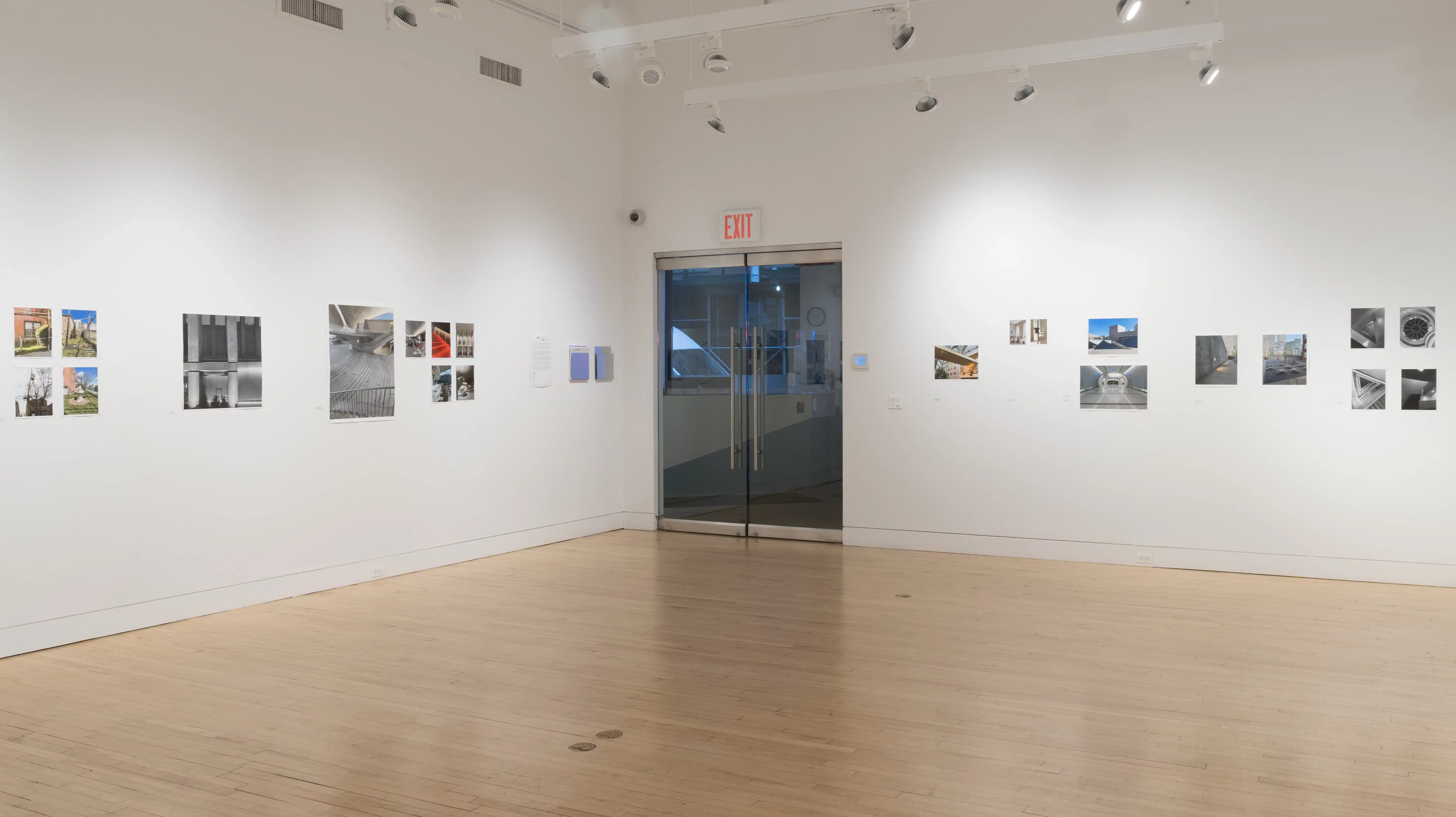 Wide shot from the other end of the Flatiron gallery, showing multiple prints and the glass gallery doors in the distance.
