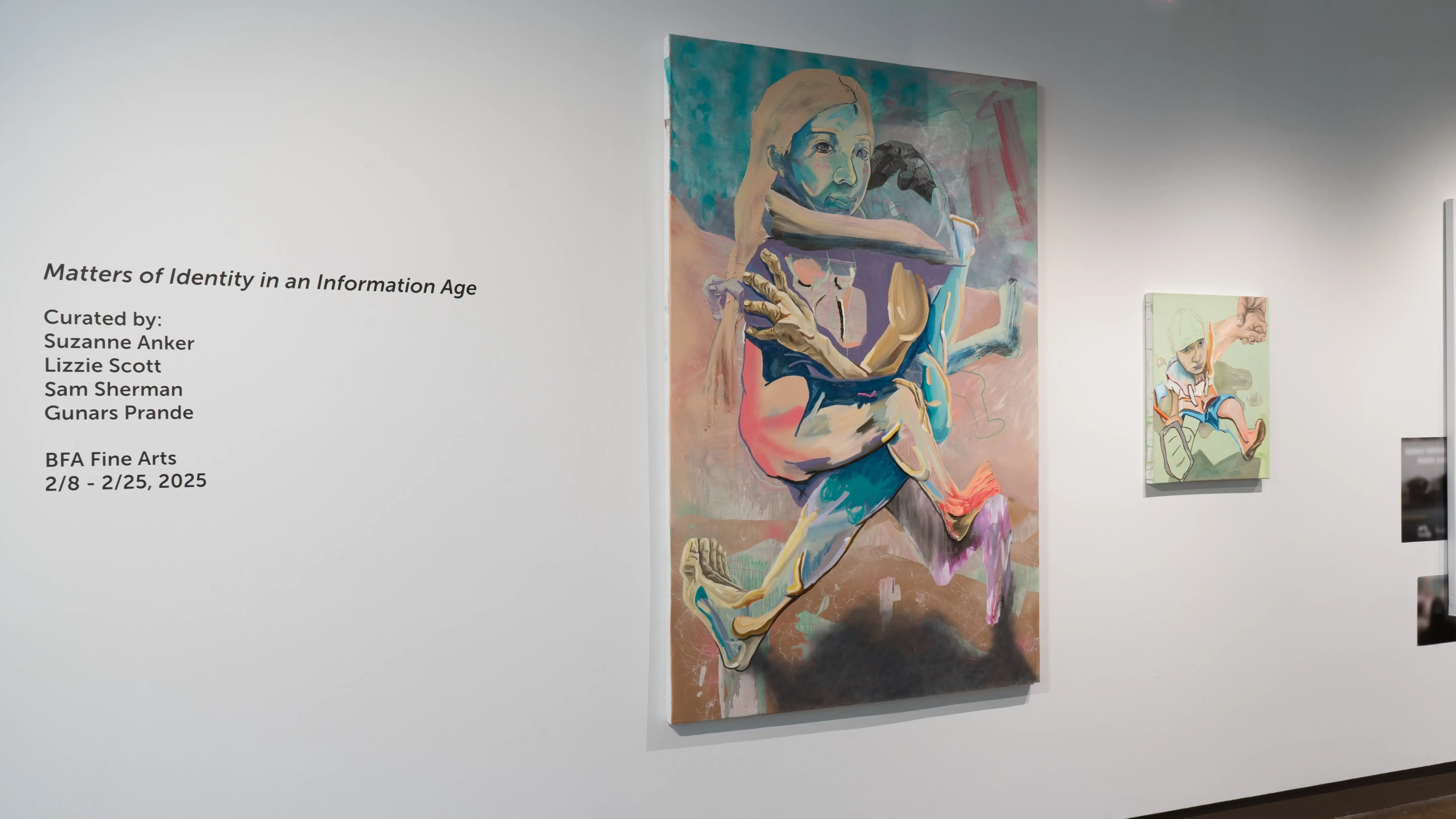 The title wall displays the title, curators, and run dates for the exhibition. To the right, a large painting and a small painting each depict partially rendered figures.