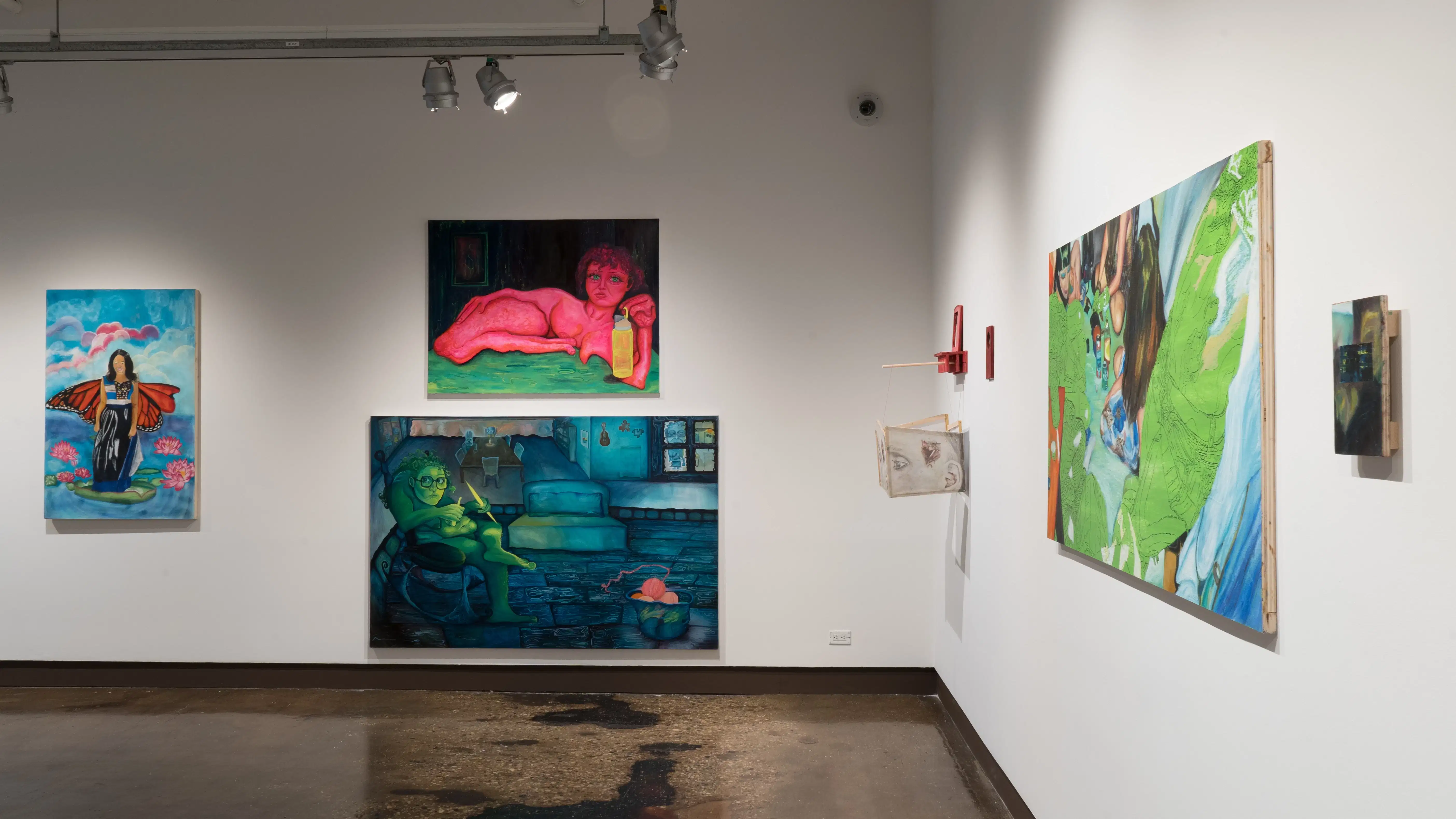 Several large figurative paintings and one installation of sculptural drawings hang in one area of the gallery.
