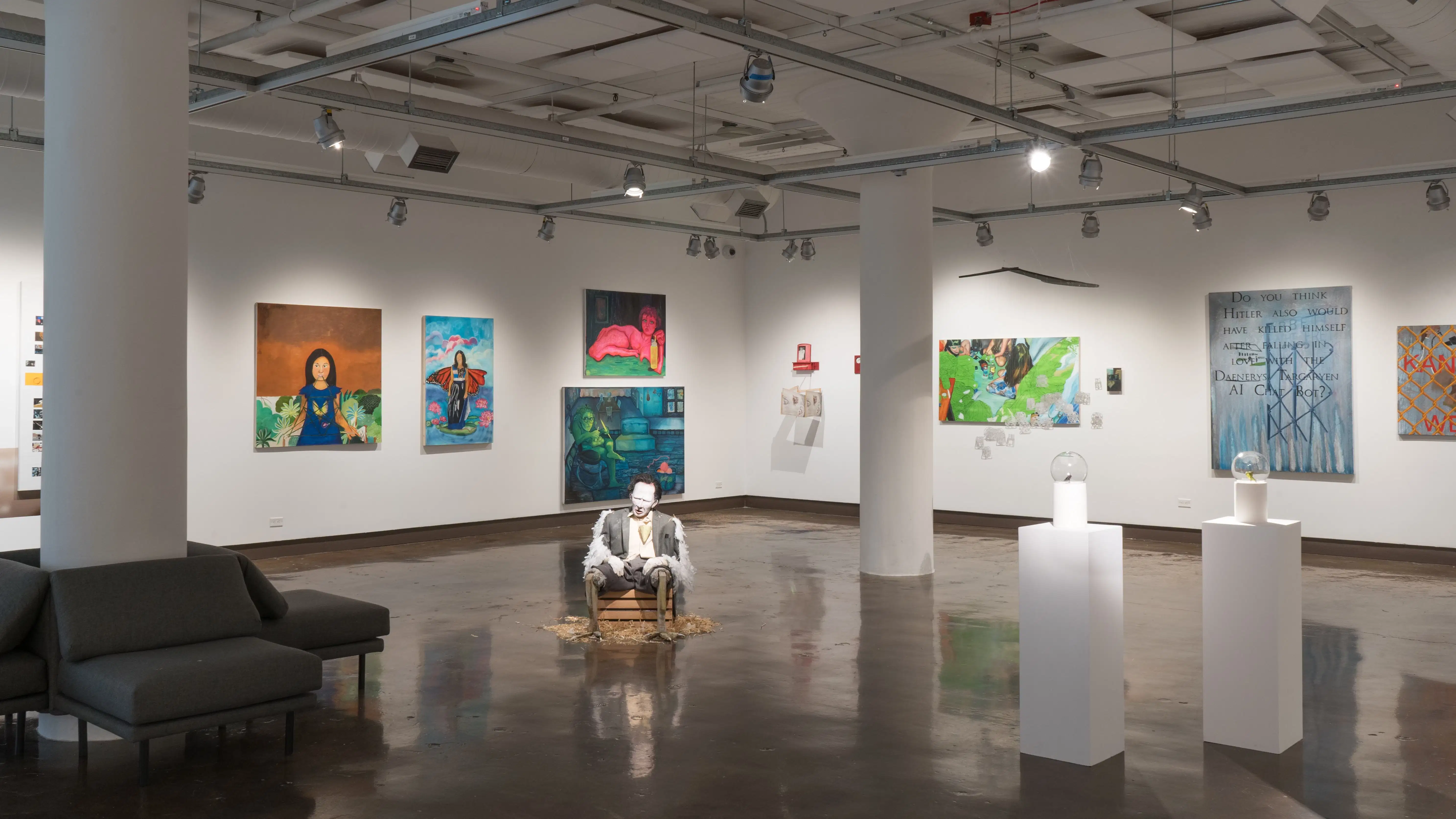 A wide view of gallery one shows a range of paintings, sculptures, and mixed media works.