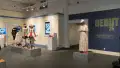 The five total mannequins dressed in costumes inspired by various items are on display in the lobby area. Behind one mannequin the wall vinyl reads “Debut 25: BFA Advertising, BFA Design Spring Show.”