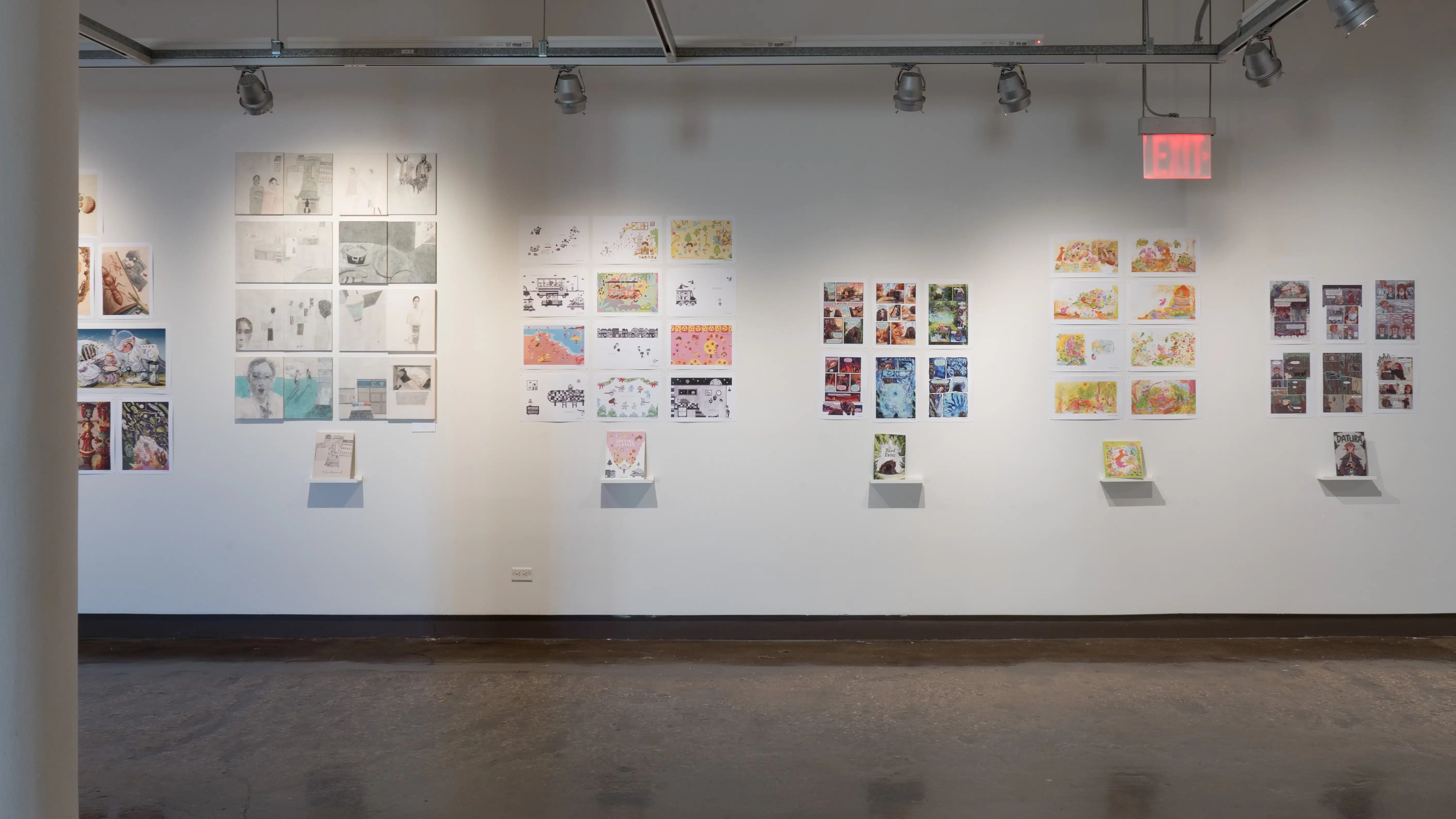 In the first gallery space, six groups of horizontal and vertical prints are displayed, with the first group of prints cut off by a pillar. The rest of the prints are all accompanied with a personalized book, displayed on separate floating shelves under the prints.