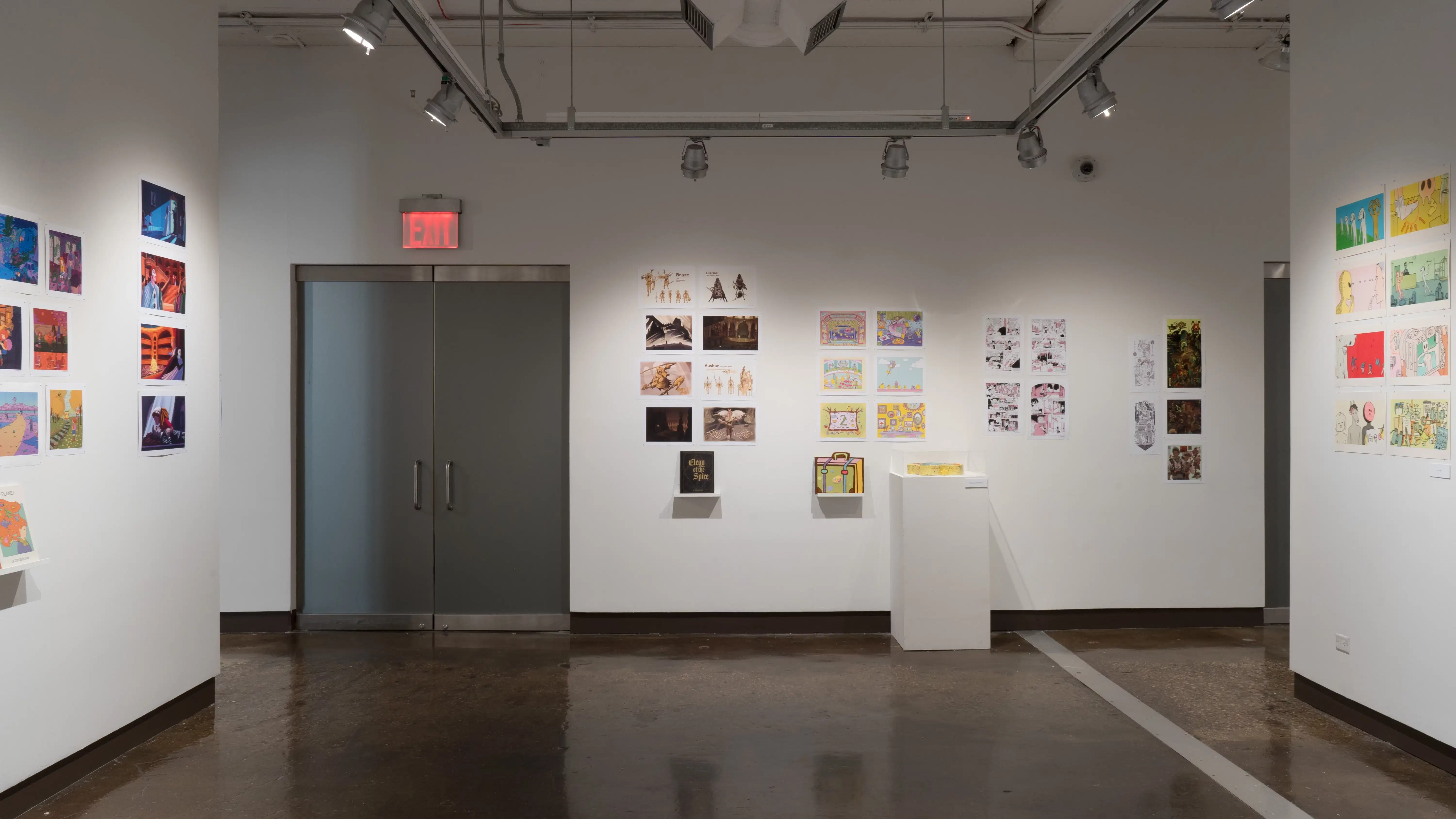 In the second gallery space, three walls are shown. On the left wall, two groups of prints are shown. One of the grouped prints on the left wall are accompanied with a book displayed on a floating shelf, under the prints. On the wall in the center shown, four groups of several horizontal and vertical prints are displayed on the wall. The first and second group of prints have a personalized book displayed on a floating shelf under the prints. The second group of prints also has a pedestal under the prints that has a sculpture displayed. On the wall to the right, a group of horizontal prints is shown.