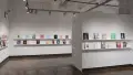Three walls, spaced out with a hallway in the middle are shown. Each wall displays various books on two long shelves. The wall to the left displays 8 books. The center wall displays 17 books. The wall to the right displays 11 books. 