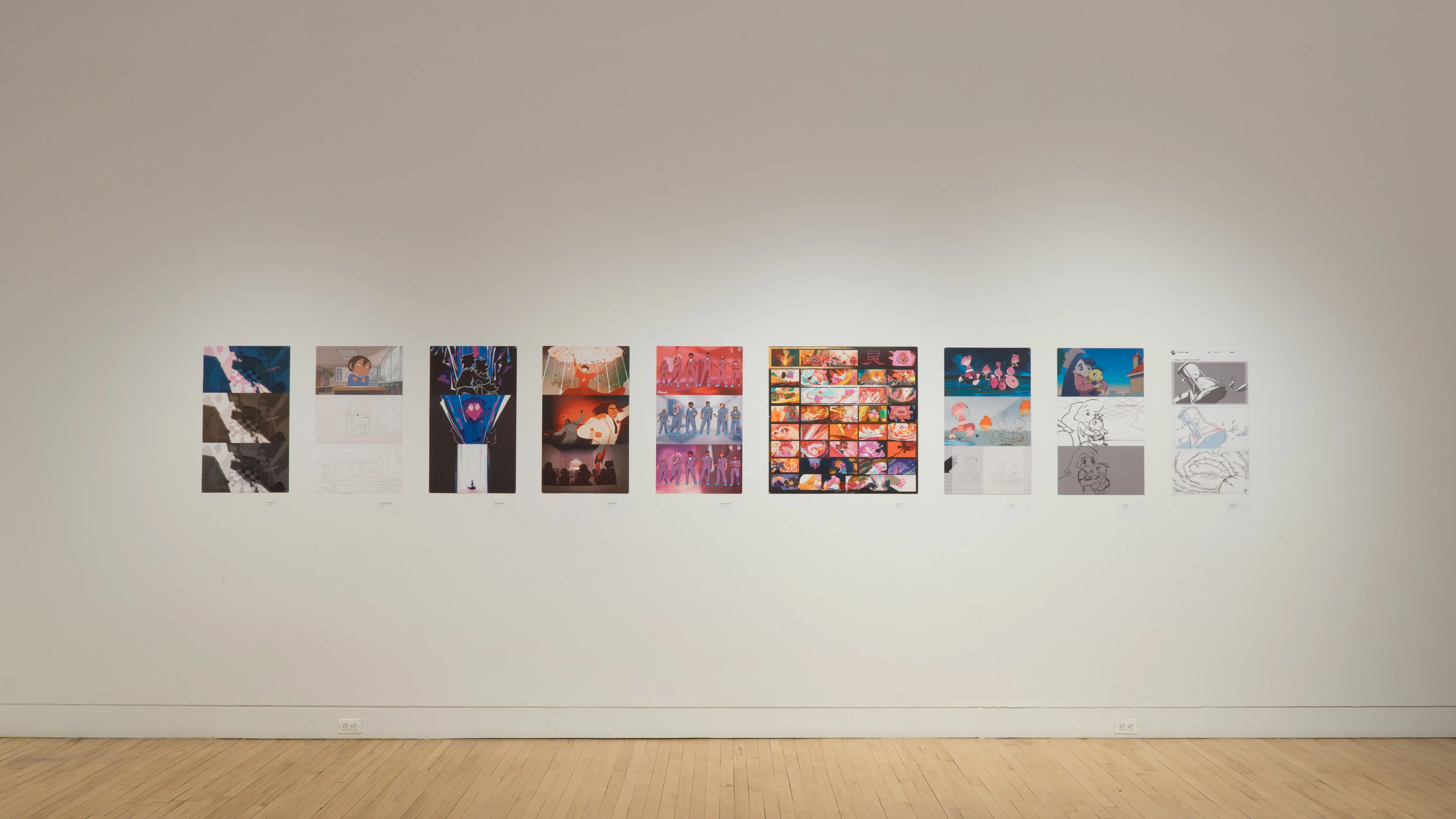 A straight shot of the SVA Flatiron Gallery's east wall, showing many colorful prints by BFA Animation students pinned up.