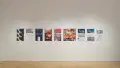 A straight shot of the SVA Flatiron Gallery's east wall, showing many colorful prints by BFA Animation students pinned up.