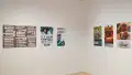 An angled shot of the SVA Flatiron Gallery's southwest corner, showing many colorful prints by BFA Animation students pinned up.