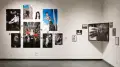 Images of fashionable young people arranged on a wall in the SVA galleries. To the right of those images is a series of black and white pictures arranged around a larger portrait of a person’s hands.