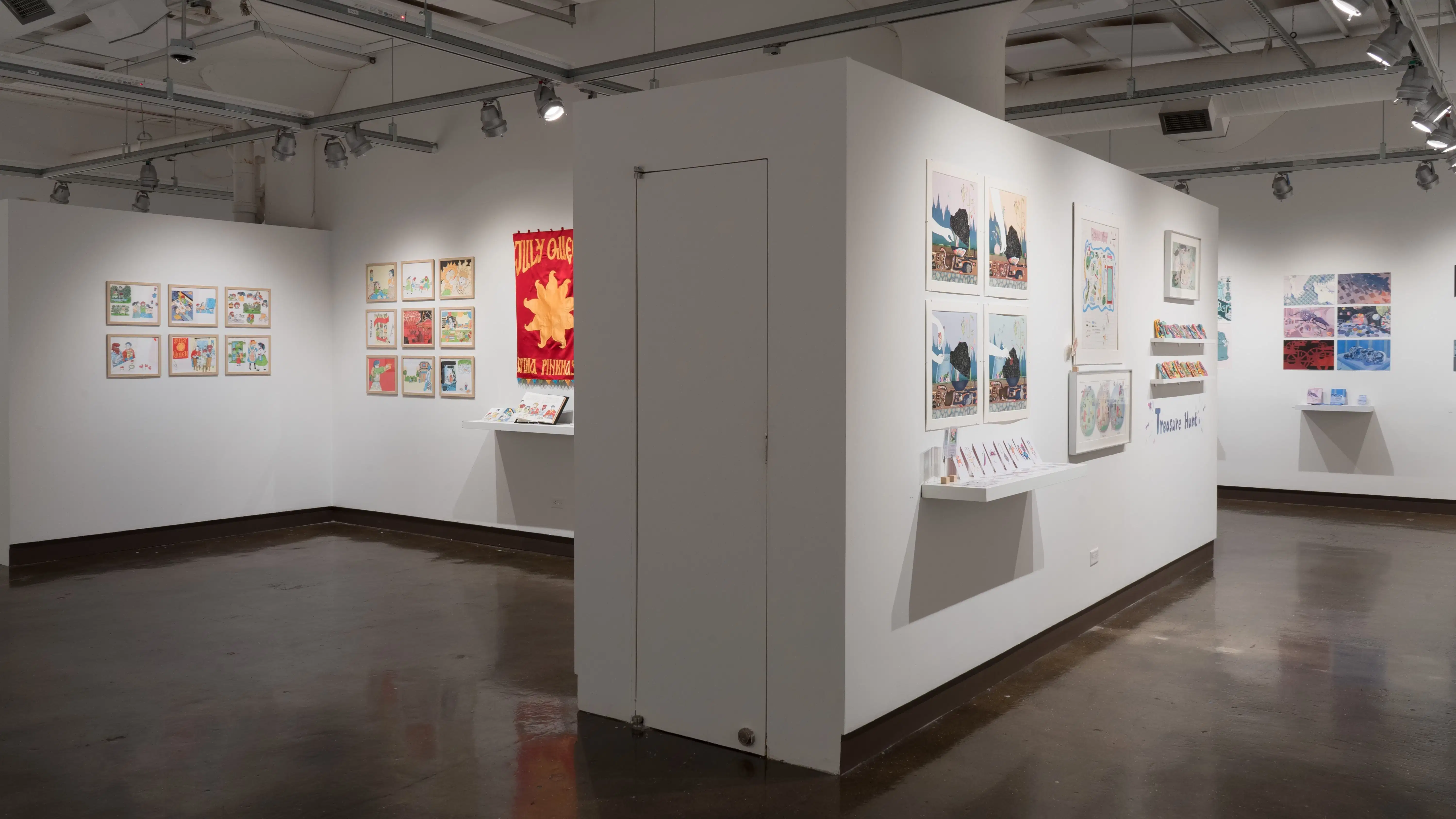 From the right hallway, illustrated works in the gallery three alcove and in gallery four are visible. Some works are accompanied by shelves holding books, postcards, or other items.