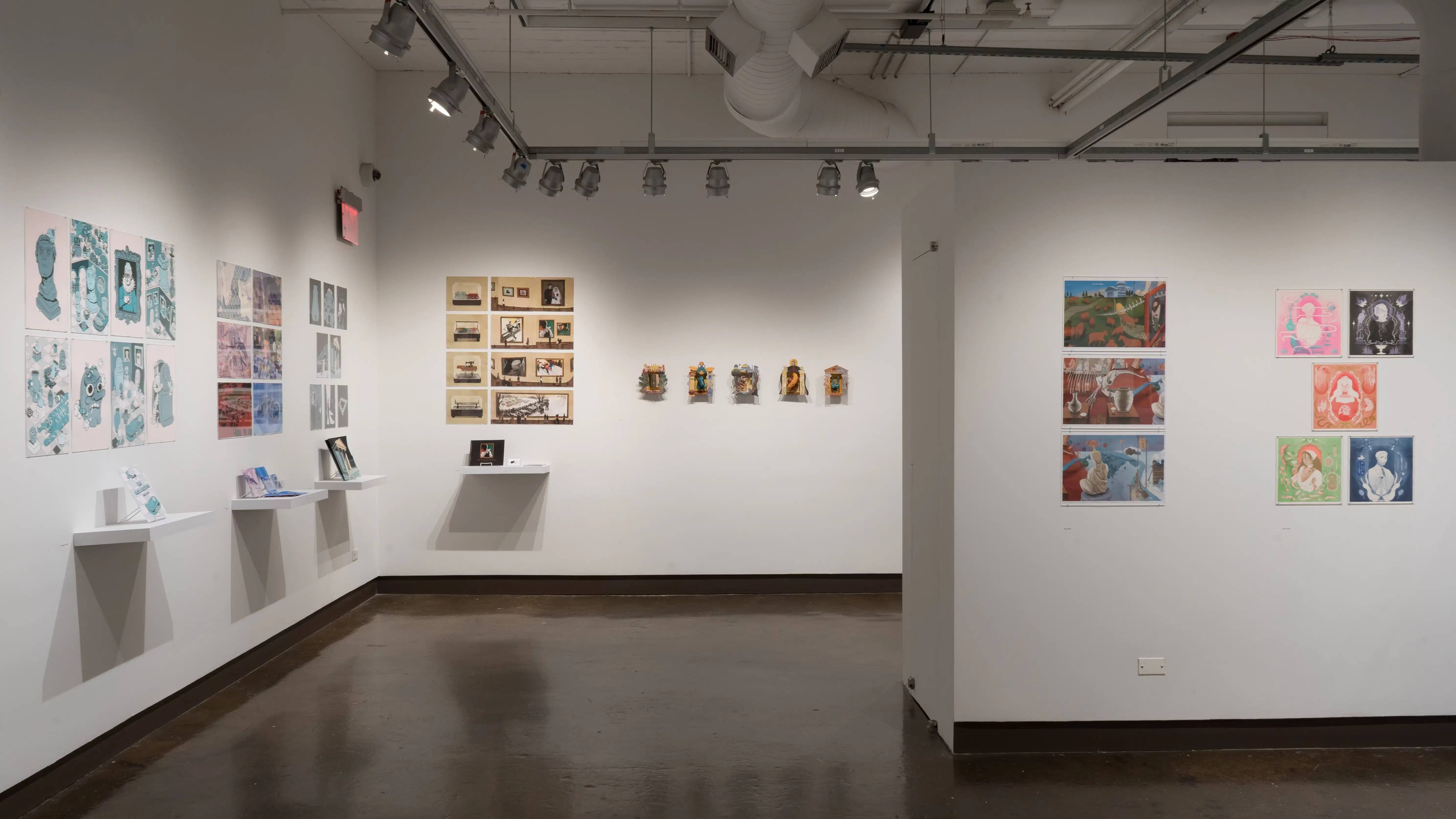More illustration projects fill the walls on the opposite side of gallery four. Most projects are made up of 6-10 prints pinned on the wall and a book displayed on a shelf beneath the prints.