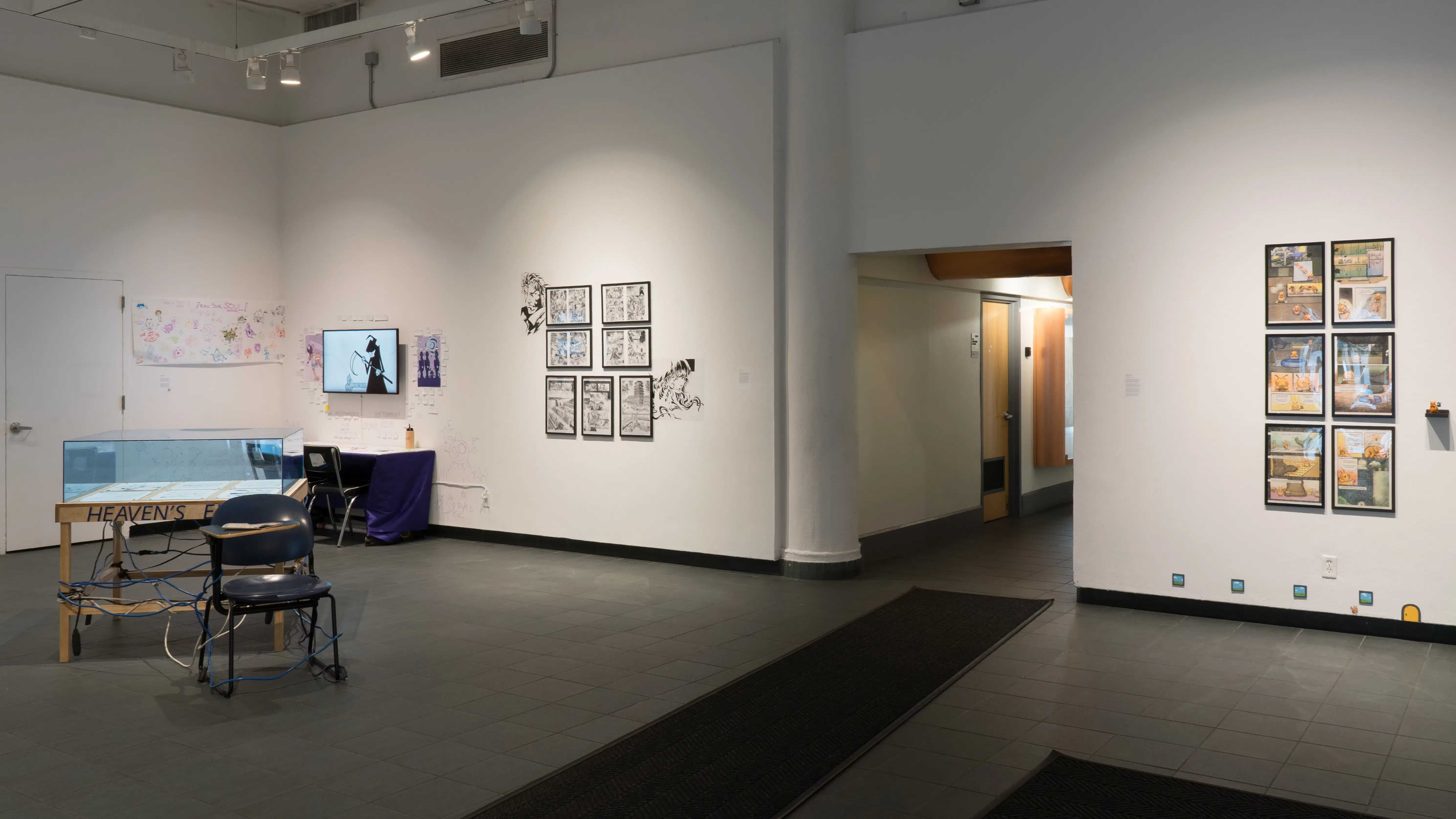 Another angle of the entrance to the Gramercy Gallery. On the left are several works in a corner of the gallery, and on the right we see six framed artworks.