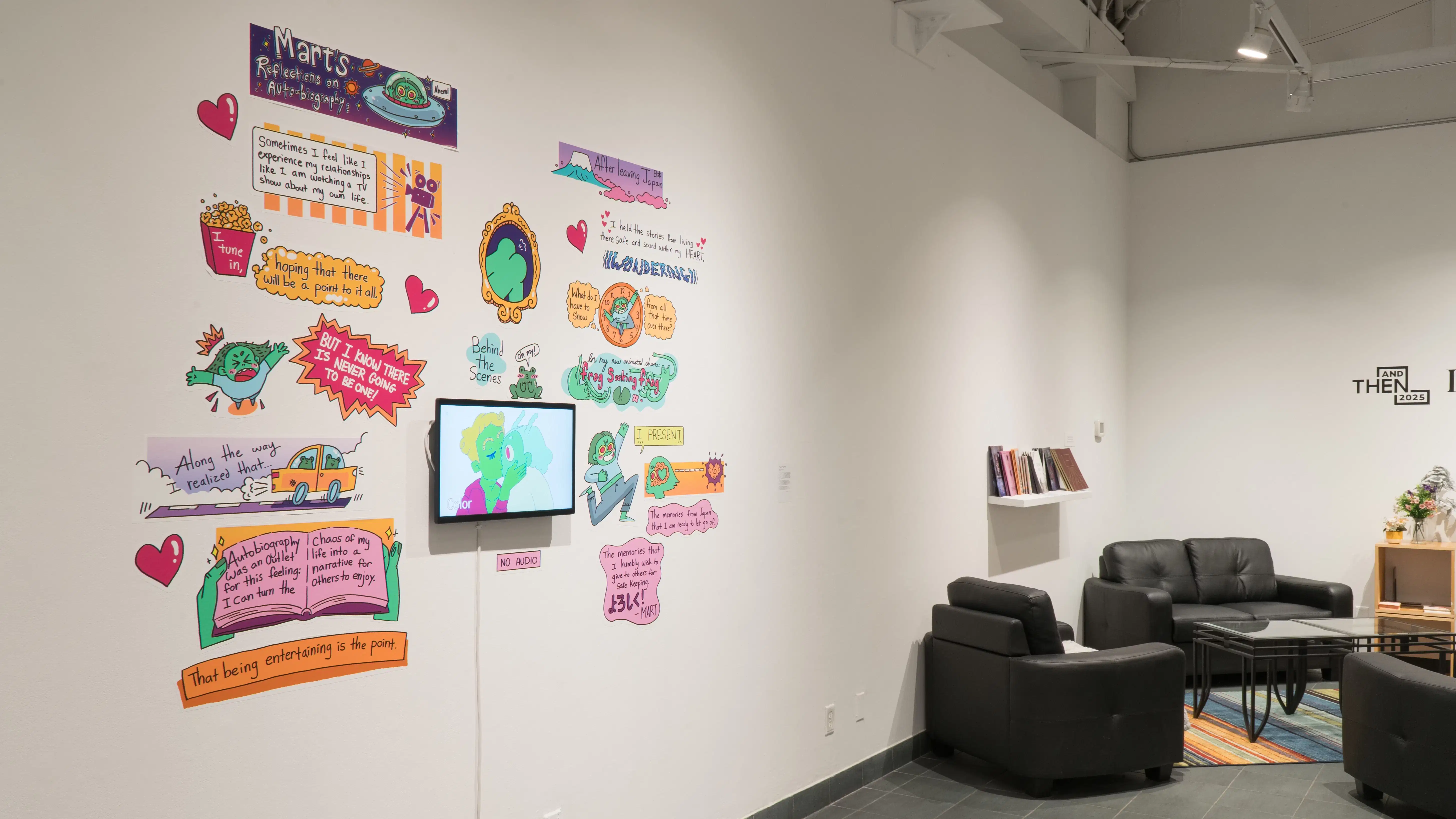 Two works in the exhibition. One is an animation that is surrounded by graphic cartoons made by the artist. The other is some chairs, a table, a shelf and a rug styled to be reminiscent of a living space.