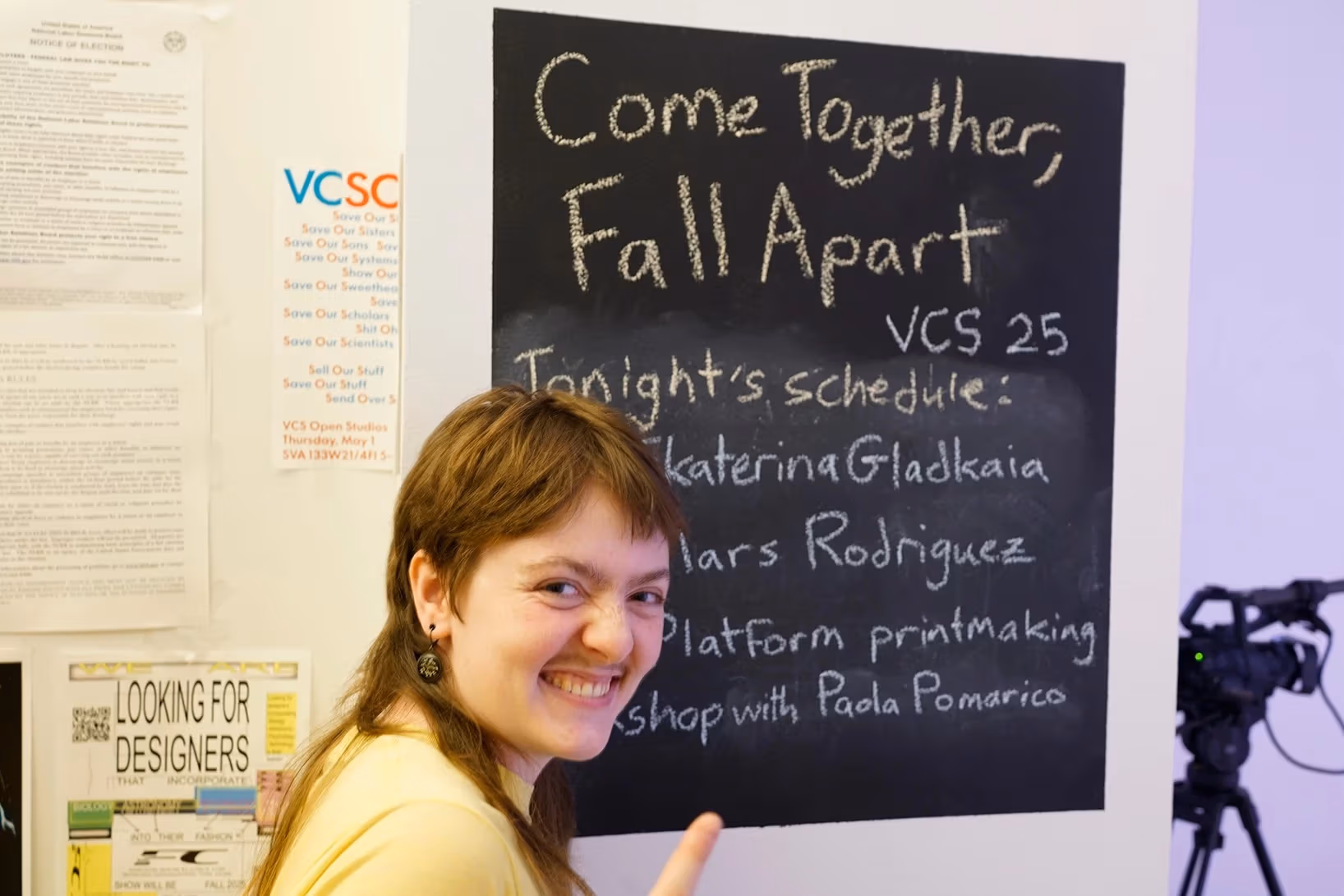 Image of the curator of the performance series Anthony O'Donnell in from of the exhibition signage.