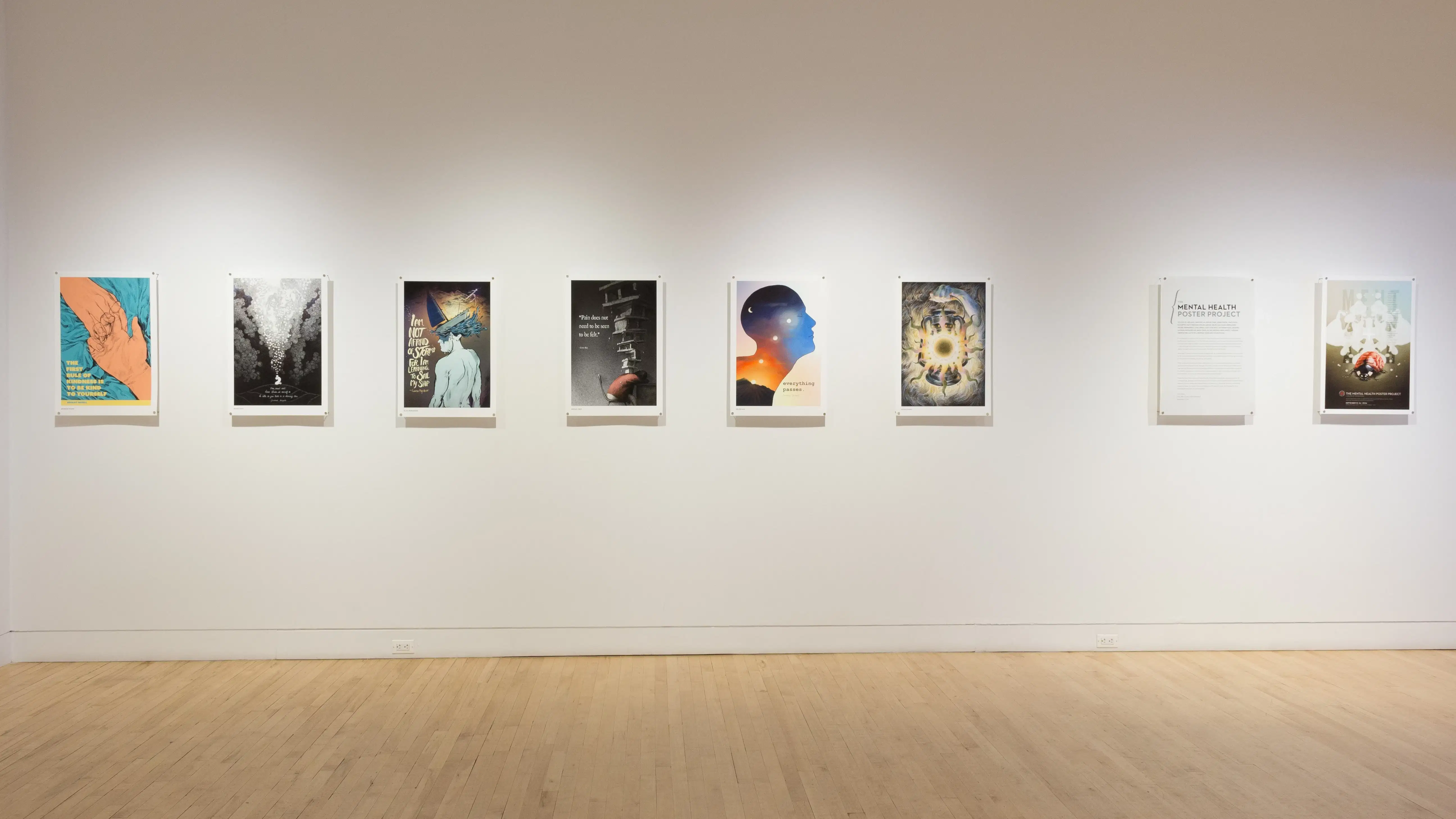 Detailed poster prints and illustrations hang in a horizontal line along the middle of the wall.