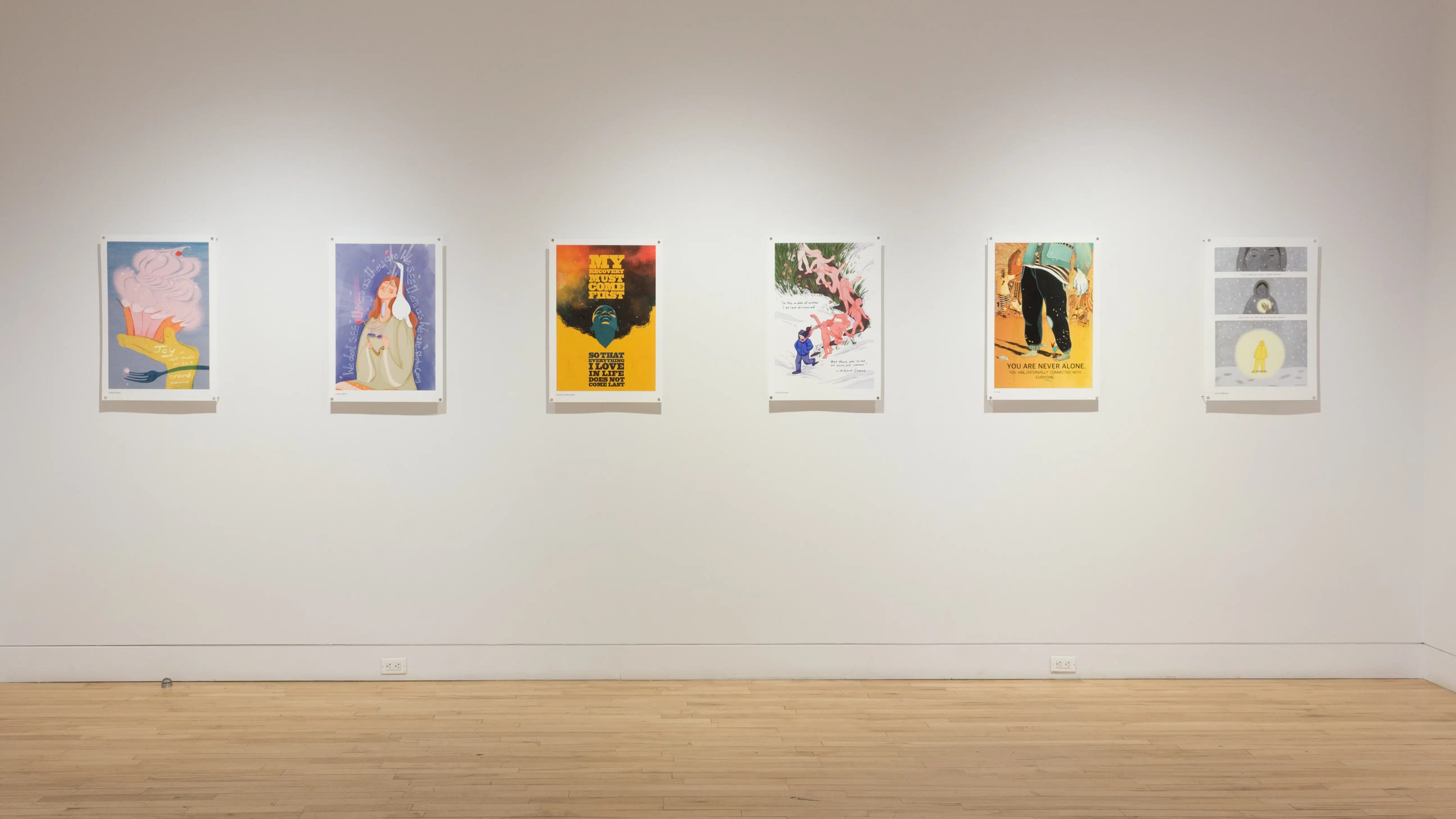 Six colorful poster illustrations hang in a horizontal row in the middle of the wall.