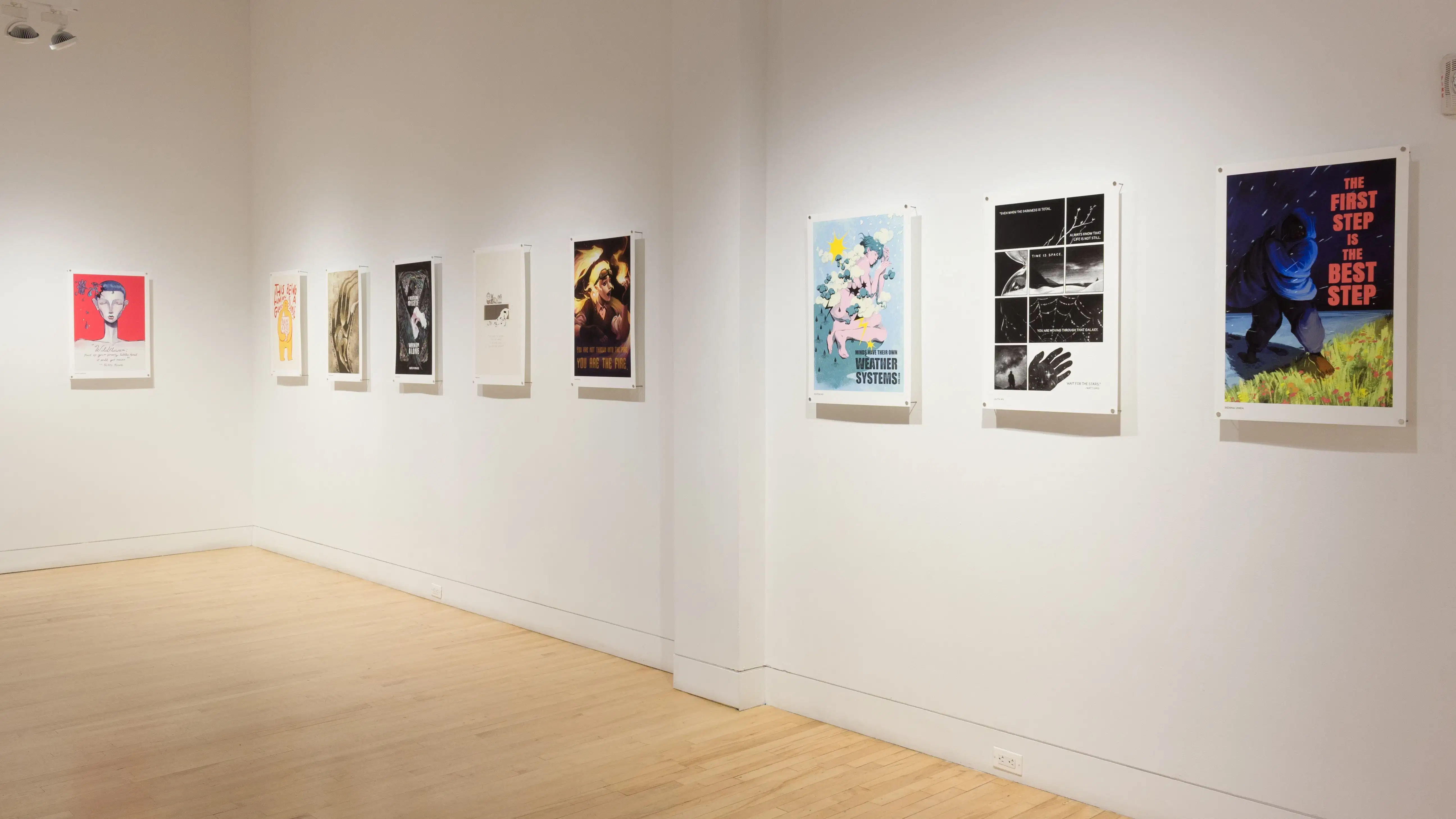 Angled view of a wall in the SVA Flatiron Gallery where nine poster illustrations hang in a horizontal line along the wall.