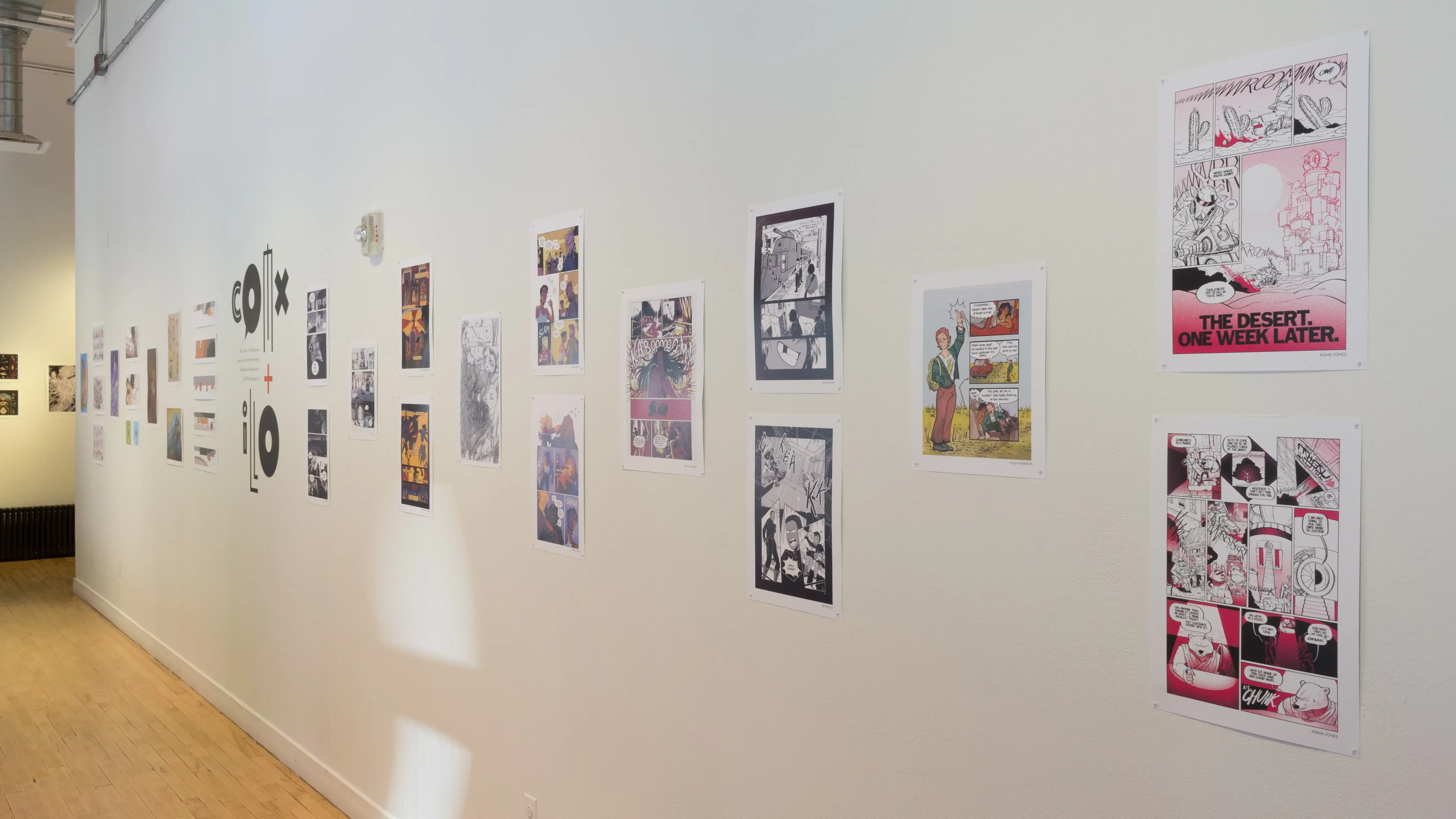 Illustrative prints hang in a horizontal staggered arrangement along the hallway of the SVA Flatiron Gallery Windows.