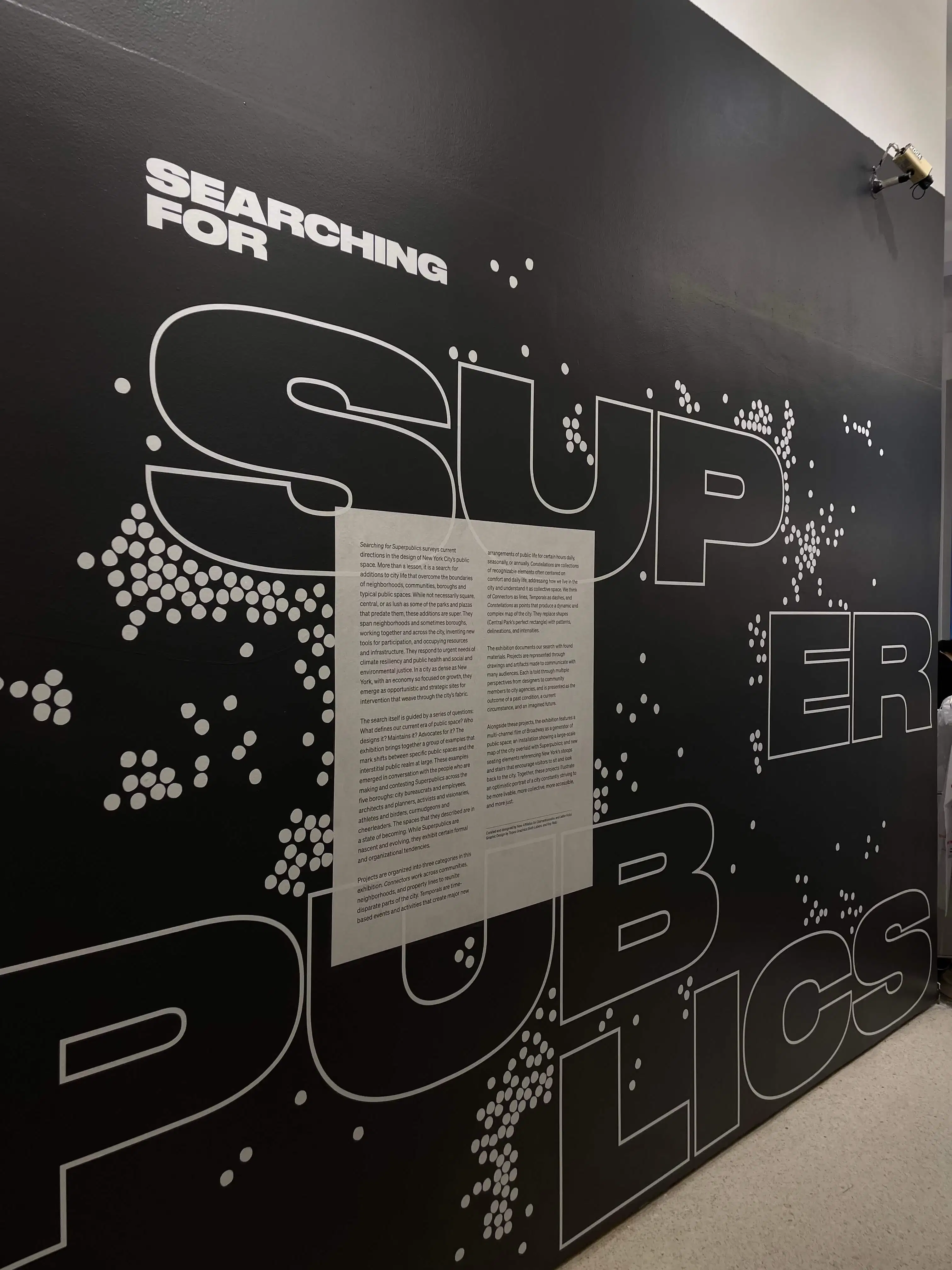 Wall text reading Searching for Superpublics