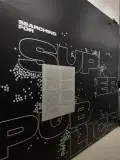 Wall text reading Searching for Superpublics