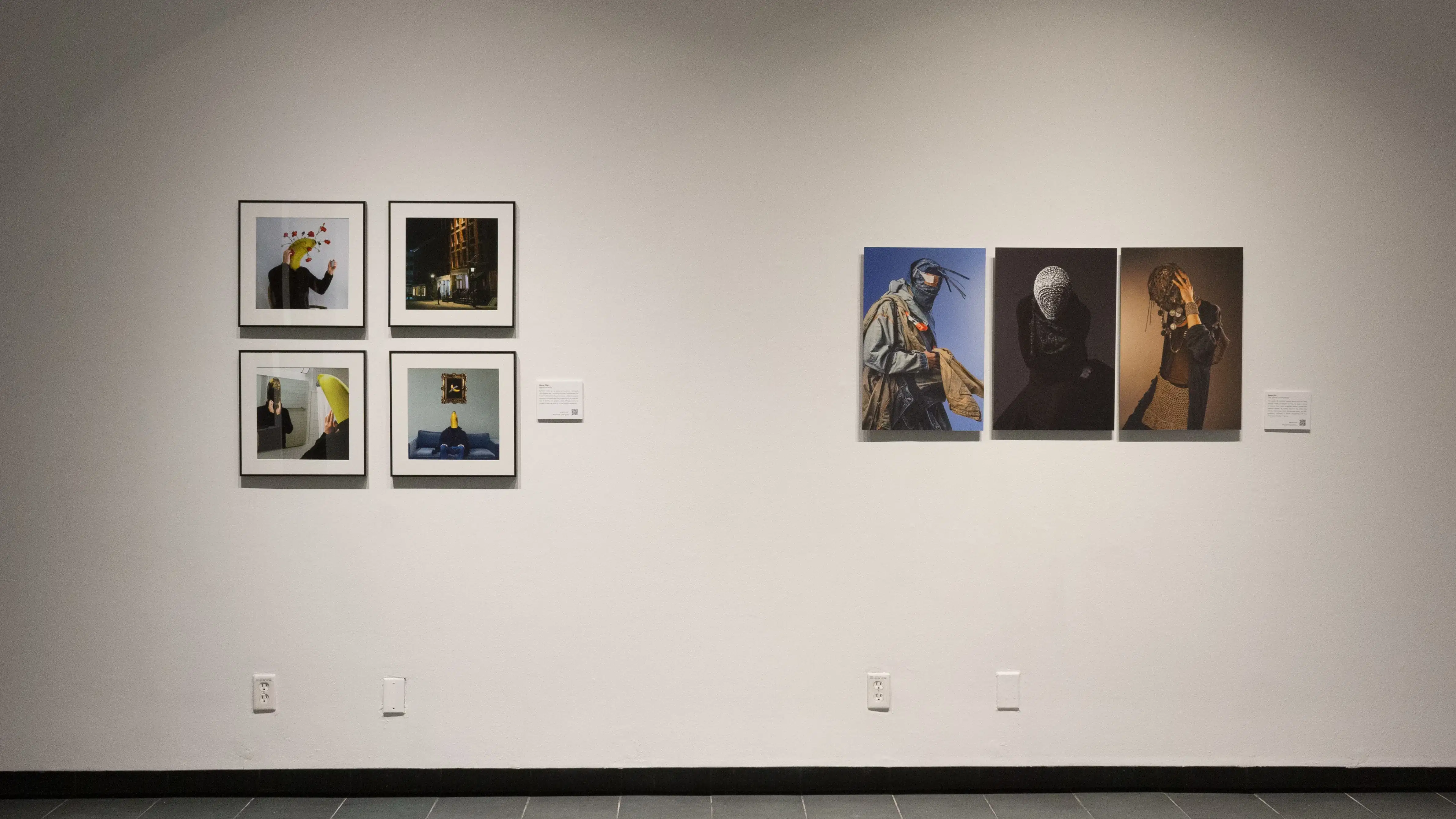 A closer photo shows the two projects, the man with the banana head and the people with their faces covered, side by side.