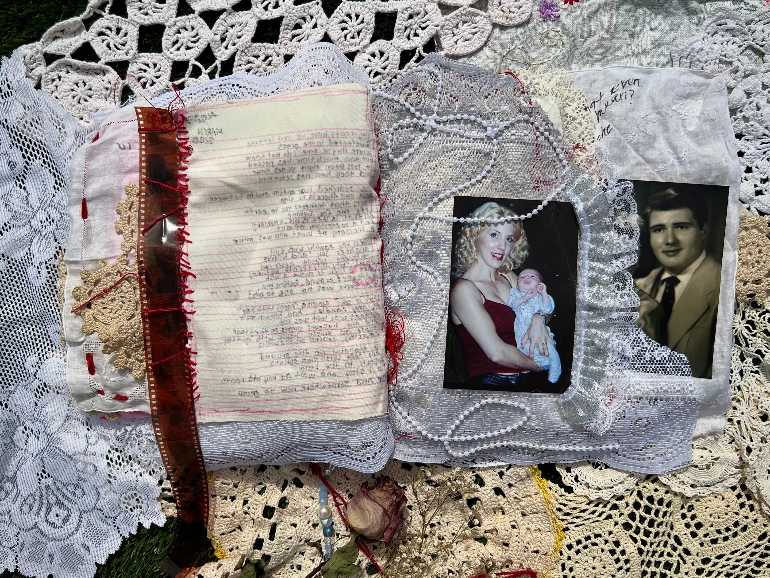 Page 9 of book. On the left-hand page, the film strip is sewn into the left edge of the fabric page. Text bleeds through from the previous page. On the right is a large piece of white lace with a photograph of a women with long curly hair holding a baby as she looks at the viewer. One long thin white beaded strip is casually placed and affixed over the woman and baby. To the right is a photograph of a man with dark short hair in a suit and tie affixed to the white linen page. He is looking at the viewer. 