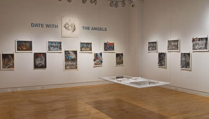 An exhibit in an art museum with various sketches on the walls.