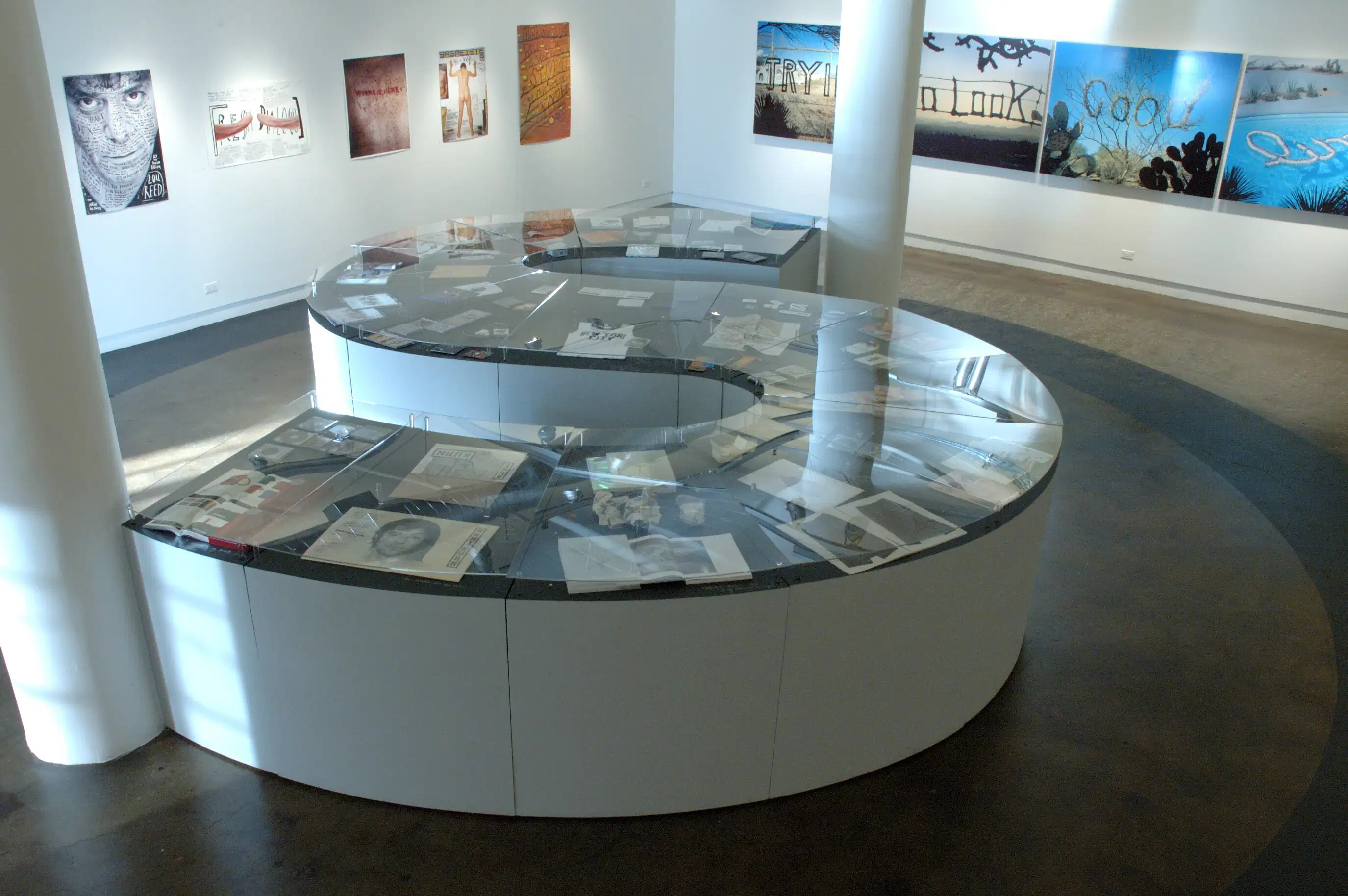 An S shaped counter has photographs all over the top.