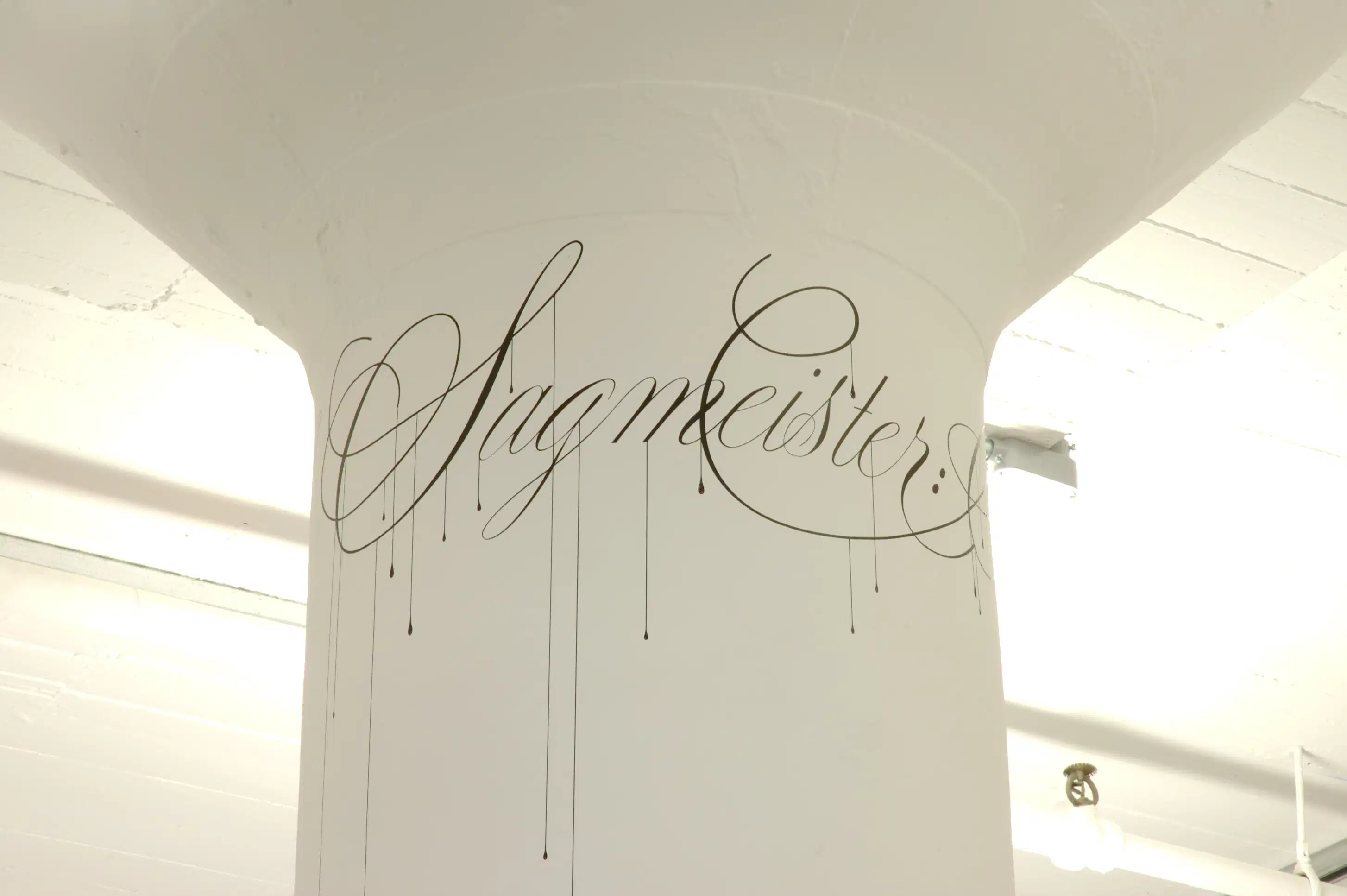 Column with a signature.  The paint of the signature is dripping.