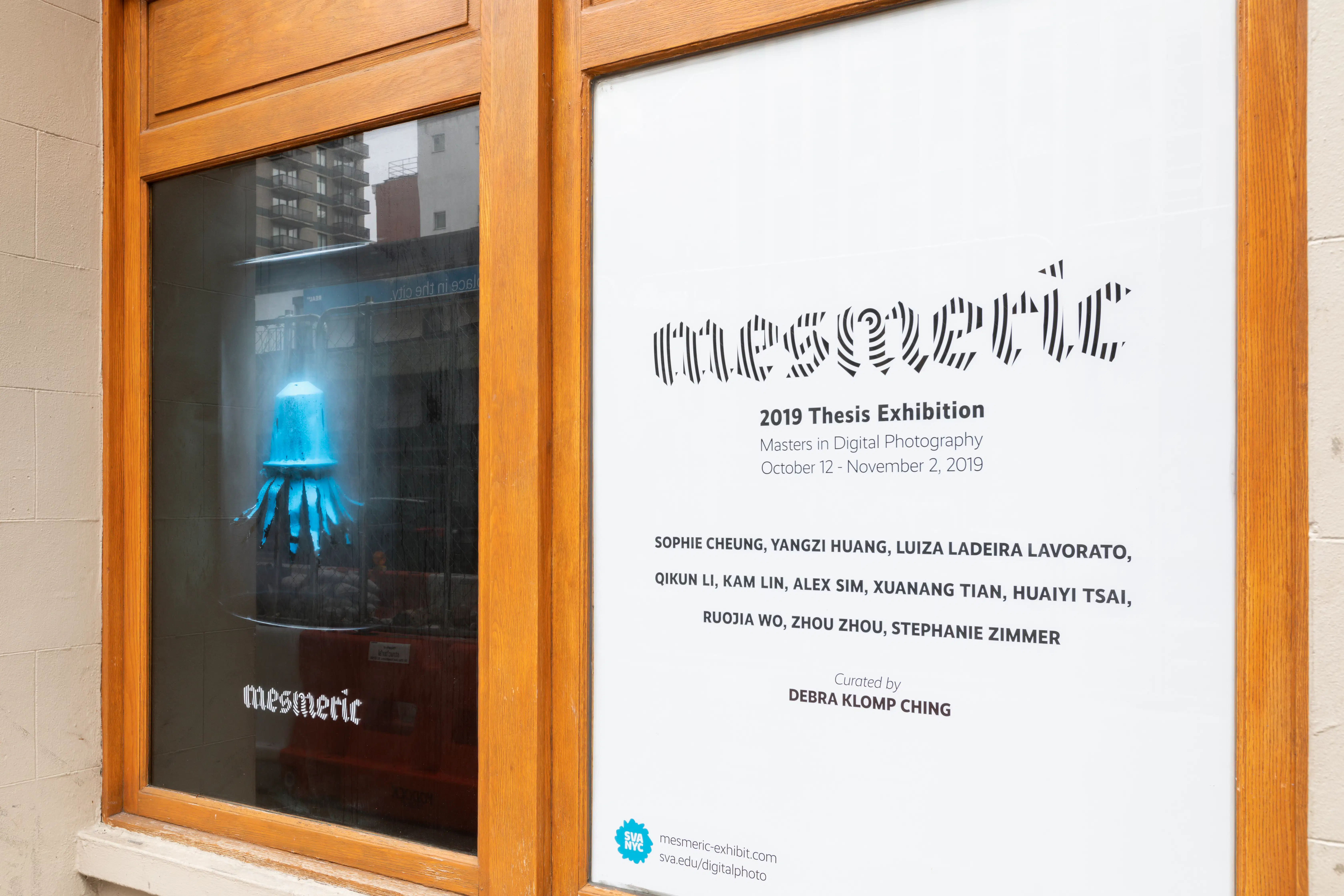 A photograph of the street window displays for the Mesmeric Exhibition
