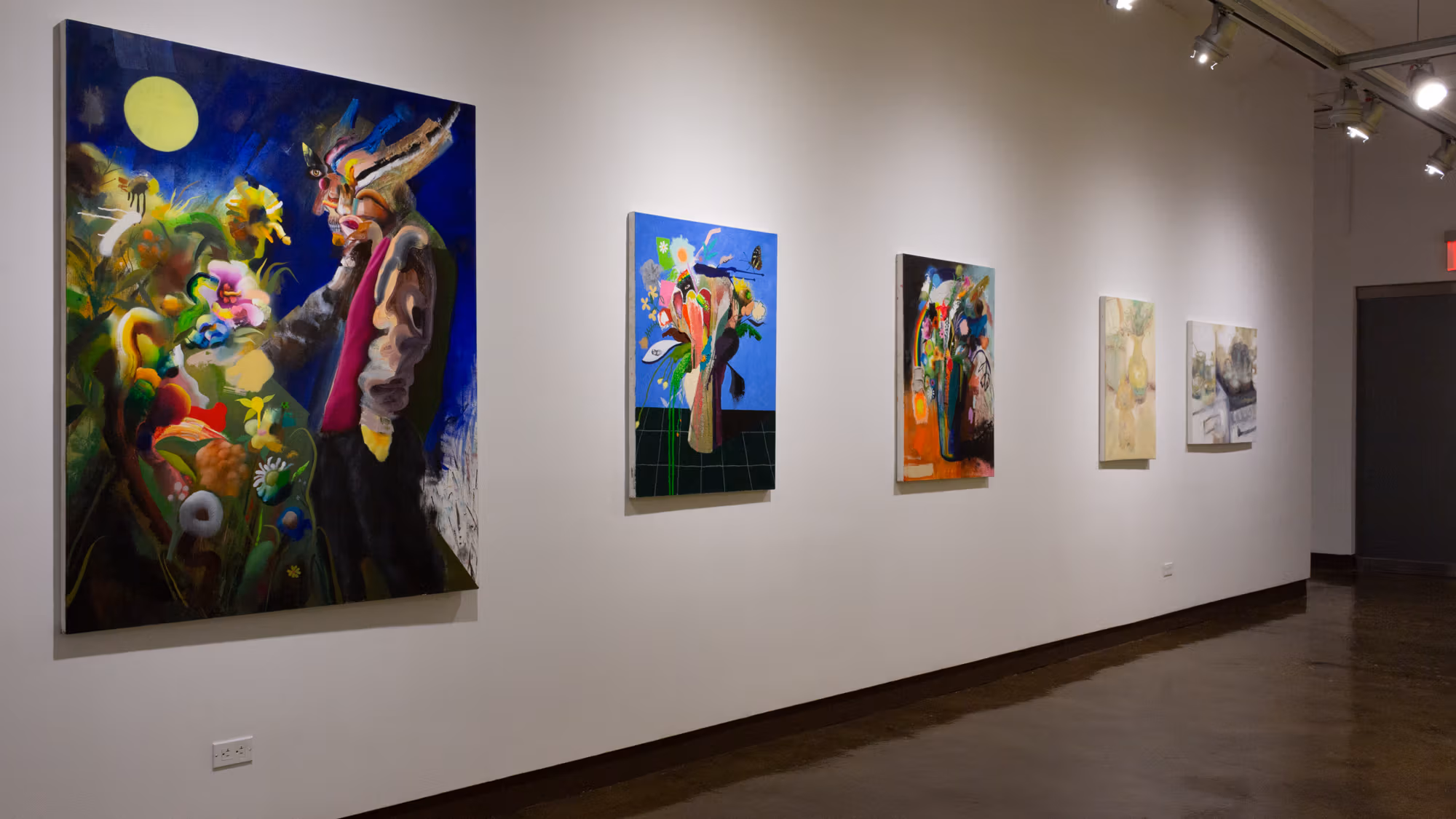 A row of five paintings hung in a horizontal row on the wall using abstract and volumetric shapes to create bouquets of flowers and other forms.