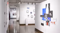 Installation shot of photographs in SVA Chelsea Galleries with four spaces visible. On the right wall is a multi-panel artwork comprised of disparate text and images.