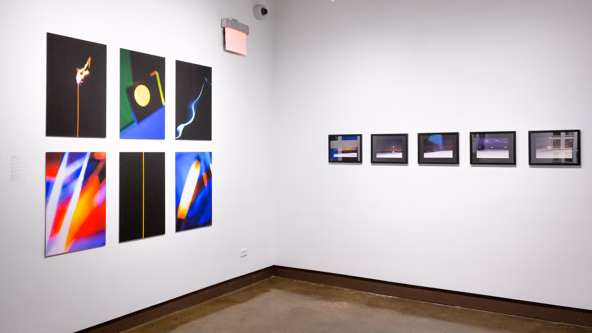 On the left are six abstract and strikingly colored images printed on panels. To their right are five night landscape images, each in its own black frame.