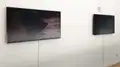 Two monitors on a white wall