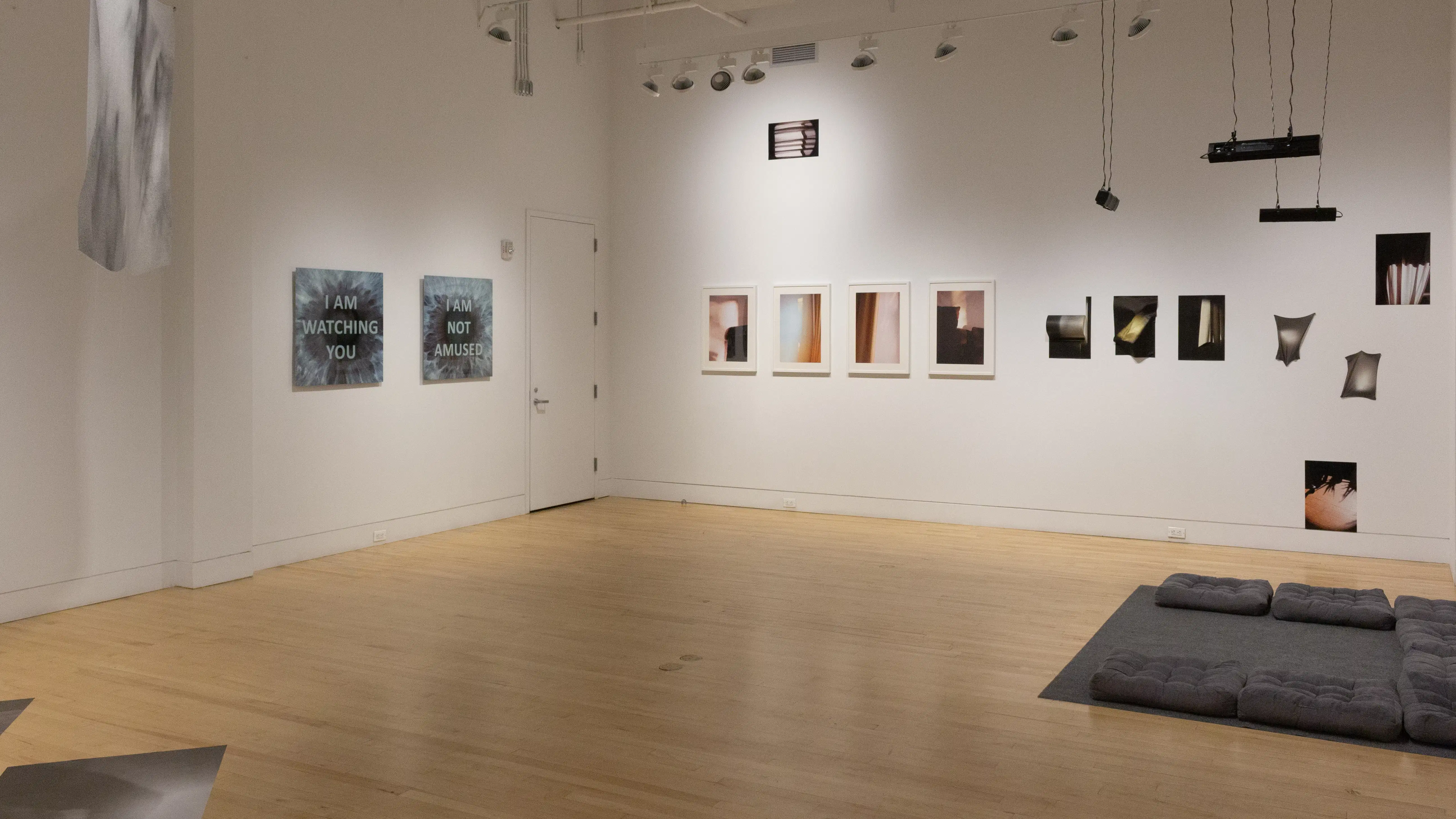 Multiple views of SVA Flatiron Gallery and Windows with installation, photographs, and textile throughout the gallery. 