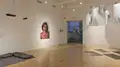 Multiple views of SVA Flatiron Gallery and Windows with installation, photographs, and textile throughout the gallery. 