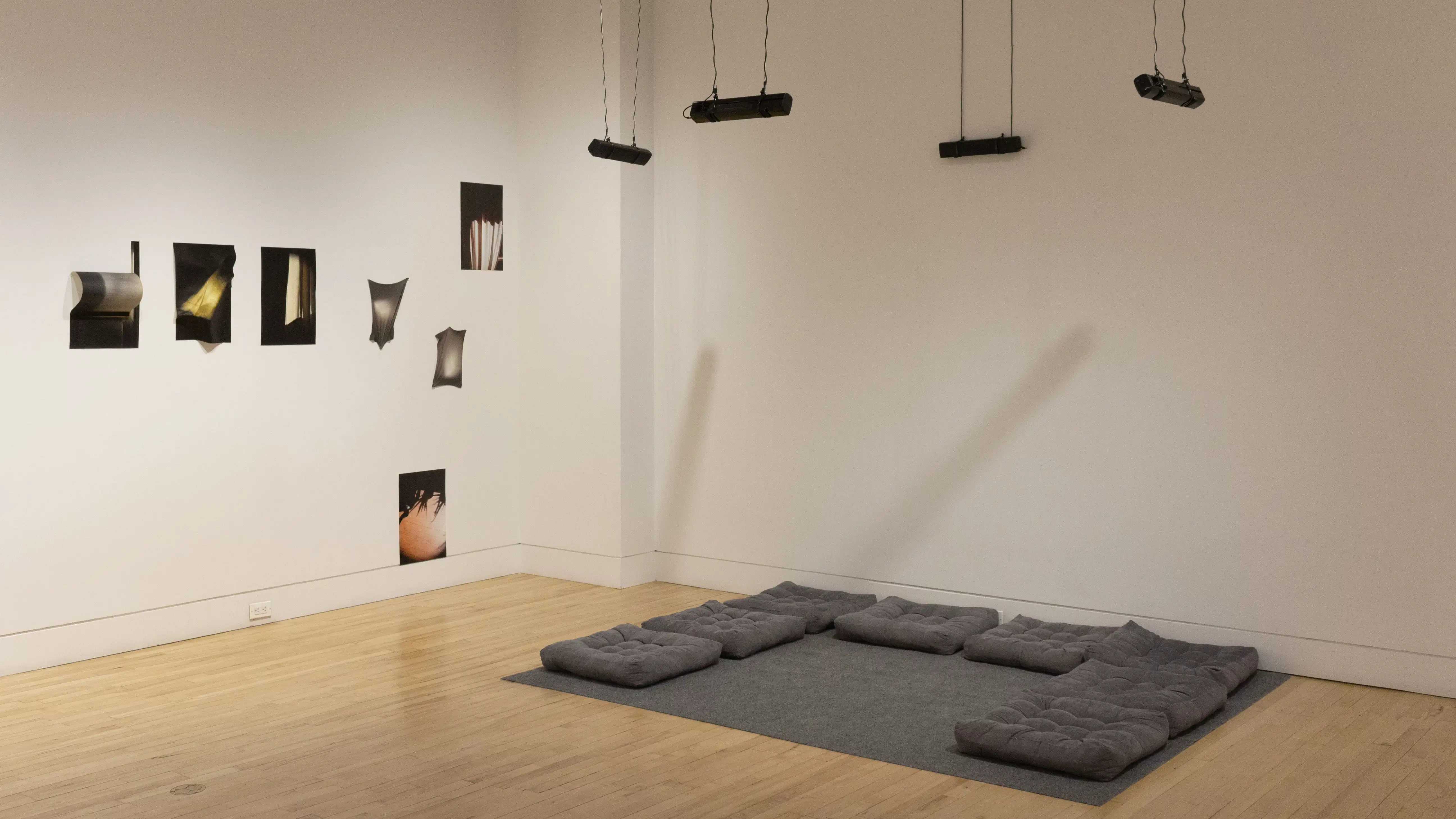 Multiple views of SVA Flatiron Gallery and Windows with installation, photographs, and textile throughout the gallery. 