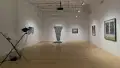 Multiple views of SVA Flatiron Gallery and Windows. There are photographs, collages, and installation work throughout the gallery and displayed in the windows. 